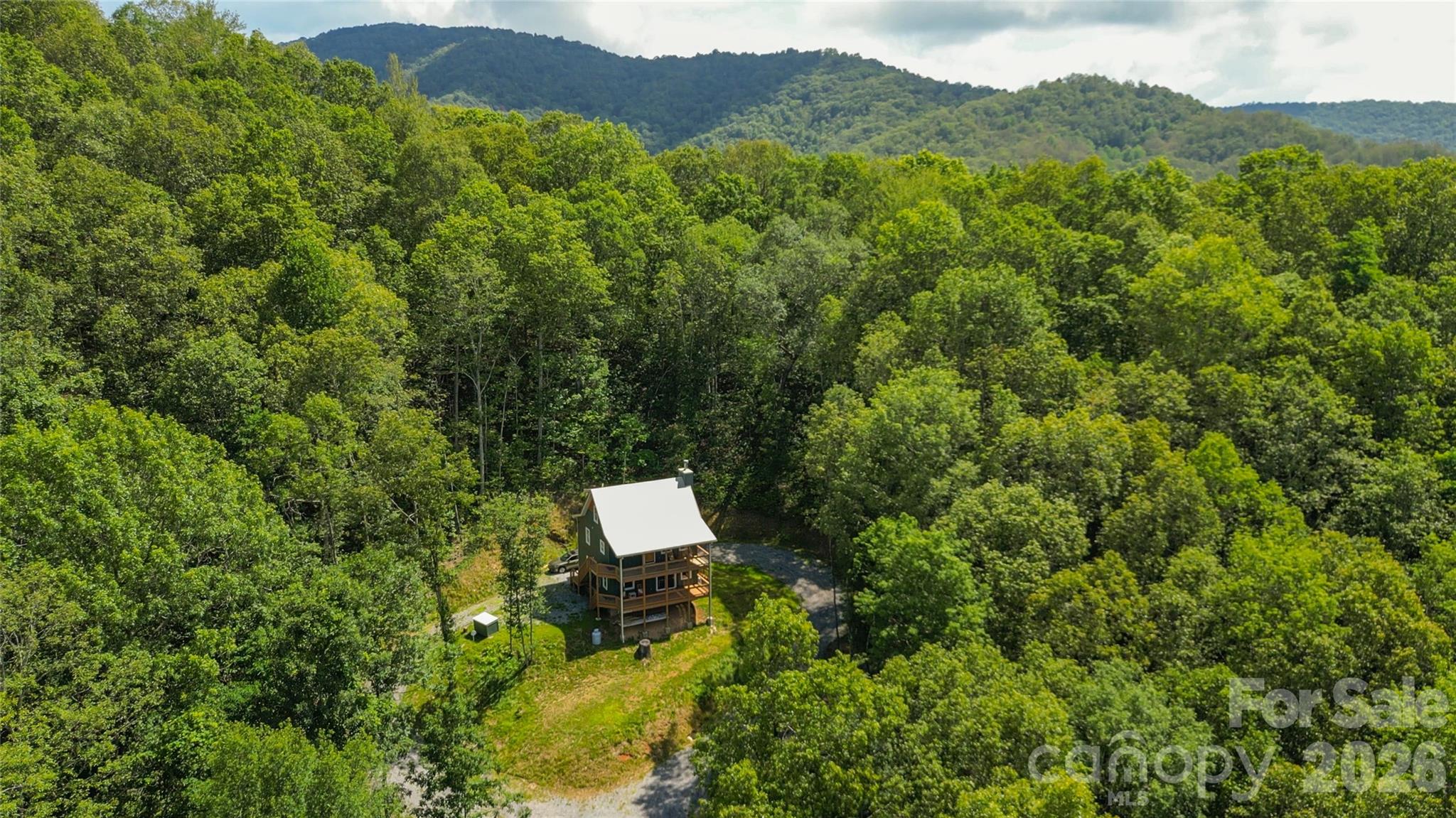 Why endure the hassle and expense of building when you can purchase this nearly new home, constructed in 2023? This fantastic property is situated on 5.71 acres at an elevation of 3,500 feet, offering a stunning Southwest view that can be improved with minimal tree trimming. The wooded lot ensures end-of-the-road privacy and cooler temperatures during the summer months. This unique two-and-a-half-level home features three bedrooms and three bathrooms, along with a vaulted ceiling and a wood-burning fireplace. You'll also find a game room, distinctive fixtures, live-edge granite countertops, and a beautifully tiled stone shower in the primary bathroom. Step outside and choose from four covered porches to relax on, or gather around the fire pit for a cozy evening. Most of the furniture is included in the asking price! Due to the layout, this would be an ideal home to convert the first level into a mother-in-law suite or separate living quarters.