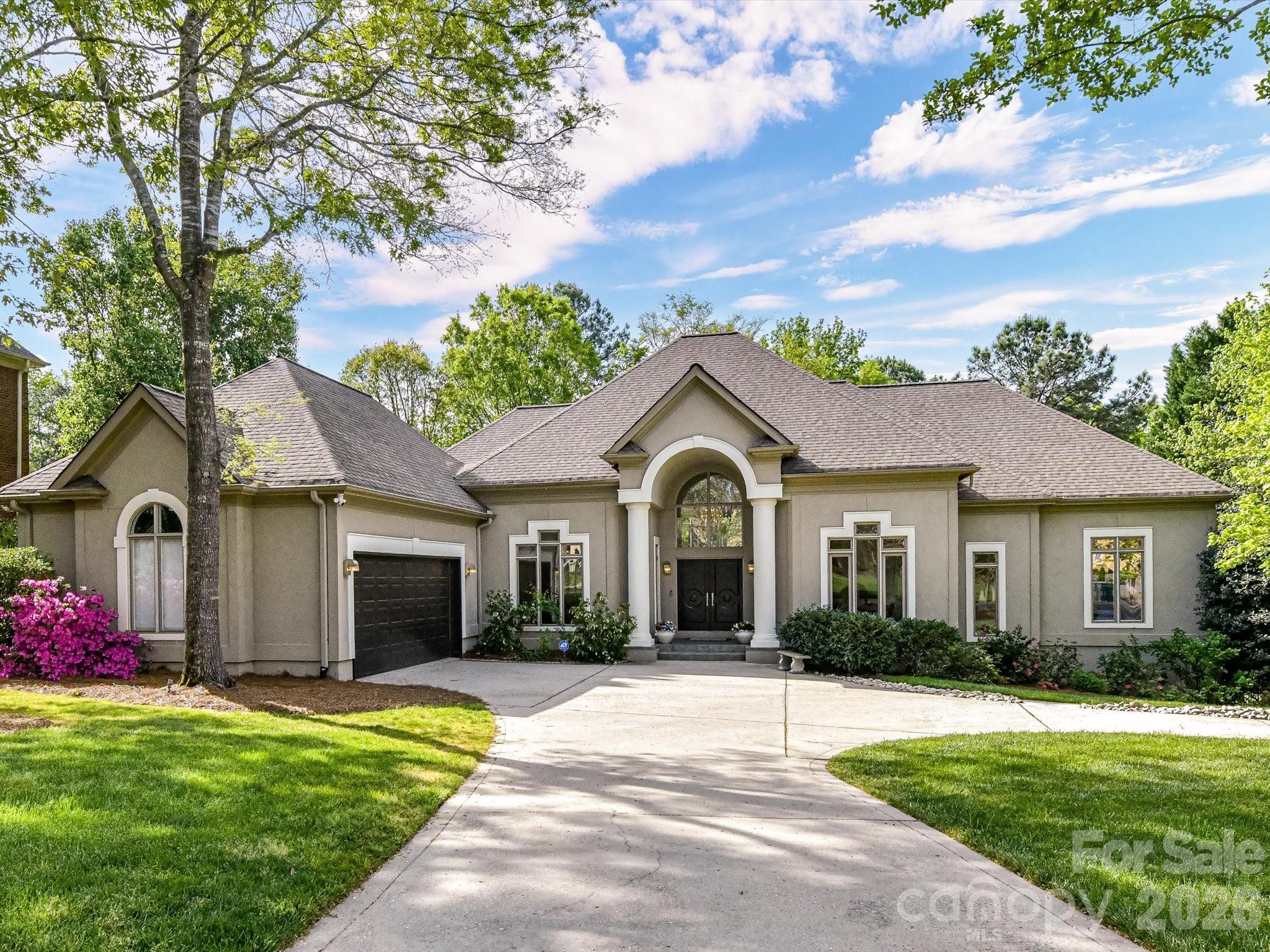 Welcome to this stunning Arcadia built home with golf course views in Ballantyne Country Club. This is a unique, highly desirable floor plan,  ranch style living with a fully finished basement. As you enter you notice the soaring ceiling in the great room with architectural design and floor to ceiling windows creating a sense of calm overlooking the backyard with gorgeous plantings.  The kitchen has been updated with quartzite counters, Thermador range hood, D/W, SubZero refrigerator, Wolf microwave and wine fridge. Custom built scullery with refrigerator and completely remodeled laundry with newer W/D.  Amazing screened porch with access to upper terrace. The primary is a true retreat with a large, private sitting area overlooking the lawn and golf course.  Updated primary spa bath and redesigned separate closets. A guest suite with updated ensuite bath, large Office, dining room and stunning powder bath complete this level. The lower level includes 2 bedrooms with ensuite baths, walk-in closets, family room flowing with natural light, 250+ bottle wine cellar, bar complete with  fridge & d/w - perfect for entertaining!
Lower level patio with grilling station and firepit. Oversized 2 car garage with epoxy floor, custom cabinets, and wall system, utility room and extra storage space.  Fenced yard and Cul de sac location. This home beautifully combines luxurious interiors with inviting outdoor spaces, offering the perfect setting to relax, entertain, and enjoy every moment.