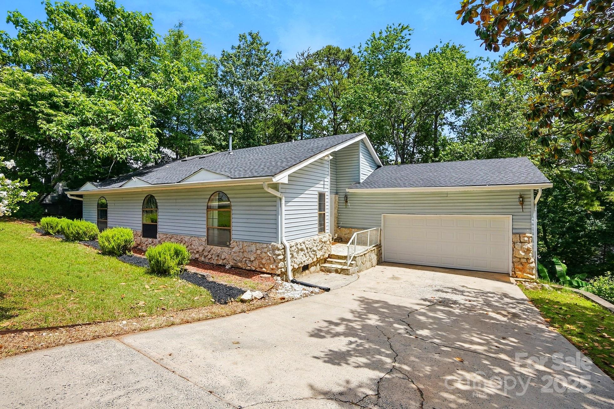 Nestled in the heart of Tega Cay, this unique 3-bedroom, 2.5-bath ranch offers charm, character, and a brand-new roof! Just minutes from the golf course, clubhouse, and a scenic waterfront pocket park on Palmyra Dr, this home boasts an open-concept design with soaring vaulted ceilings and a unique two-story stone fireplace in the main living area. The heart of the home is the kitchen, and this one is ready to host family and friends. Gather around the the island or enjoy a meal in the spacious breakfast area. The attached two-car garage provides convenience, while the 924 sq. ft. walkout basement offers endless possibilities for expansion. This home is a true Tega Cay gem there is so much to love about it's unique architecture. Don't miss this fabulous opportunity just waiting for your personal touch! Zoned to award winning Fort Mill Schools. Tega Cay is an amenity rich community offering a lake vacation lifestyle, parks, trails, golf, swim, marina, pickleball, and so much more!