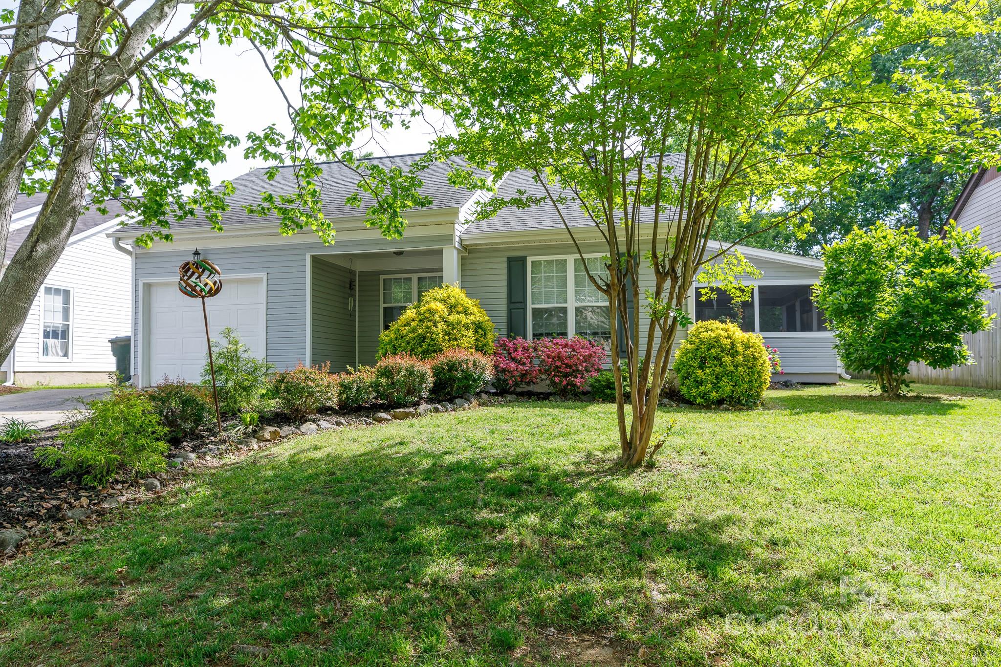 Completely remodeled inside and out, this beautiful home is move-in ready with thoughtful updates throughout. The stunning kitchen features granite countertops, brand new soft-close cabinets, tile backsplash, and stainless steel appliances—including the refrigerator. The spacious primary suite offers a tray ceiling, walk-in closet, and updated en-suite bath. Relax on the welcoming front porch, screened side porch (with included furnishings), or back deck overlooking the fenced yard. The exterior was fully updated in 2023 with new vinyl siding, double-pane windows, storm and screen doors, gutters, lighting, and more. Inside, enjoy all-new flooring, paint, fixtures, bathrooms, and a fully upgraded kitchen. The attached garage has also been finished with insulation, new walls, poly floor tiles, and fresh paint. Washer/dryer, garage fridge, and even a dog door are all included—every detail has been considered. Conveniently located near shopping, dining, and easy access to the interstate.