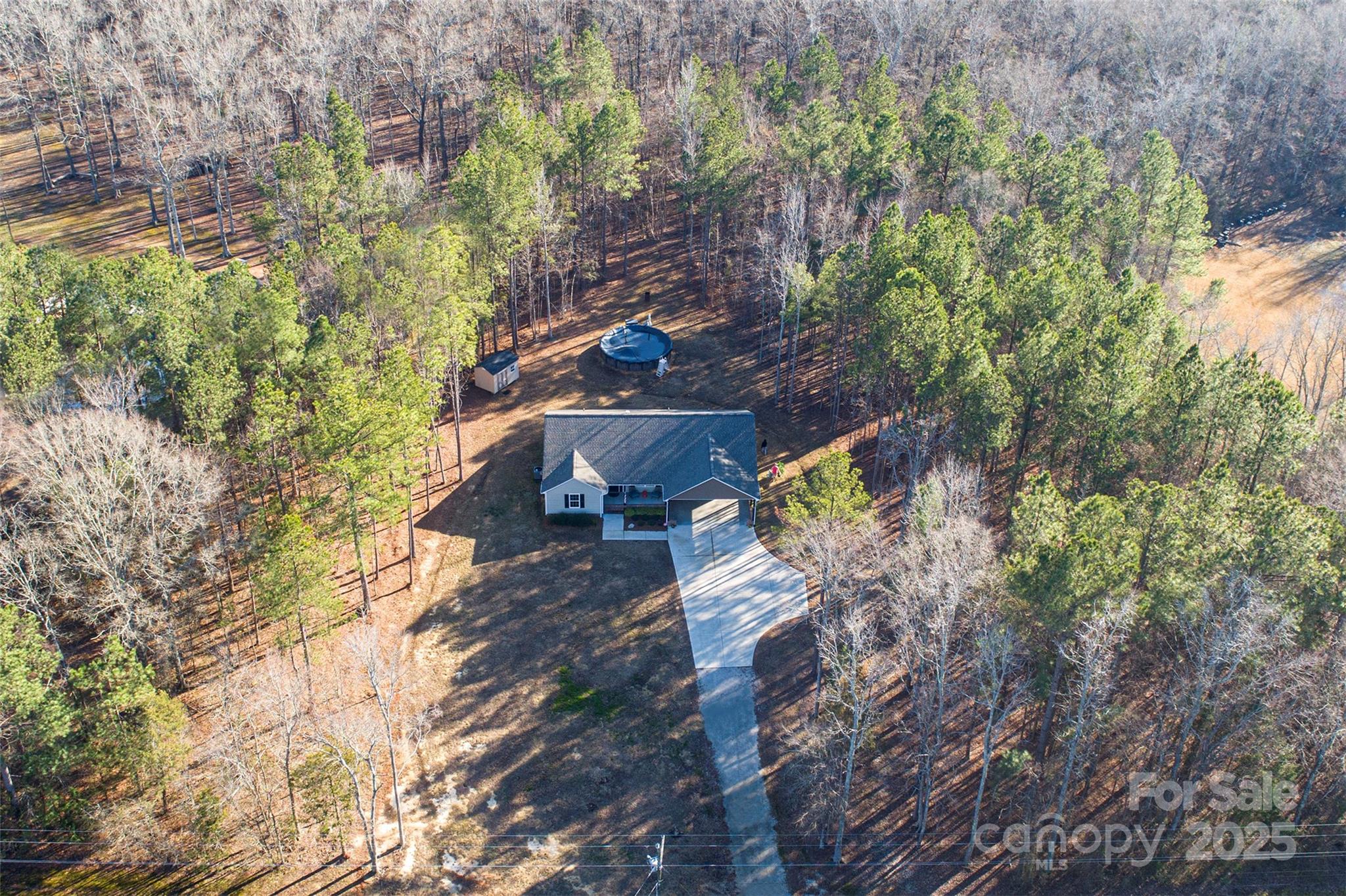 Nestled on nearly 3 acres, this spacious three-bedroom home offers the perfect retreat for those seeking privacy away from the hustle and bustle. Built in 2022, and only 15 min away from the main shopping area and hospital,  this residence features an open layout with abundant natural light, luxury vinyl plank floors, and ample storage space. Its modern kitchen is equipped with stainless steel appliances, granite countertops, soft-close doors and drawers, and a central island.  The primary bedroom is generously sized, boasting a walk-in closet and a luxurious bathroom with a double vanity and shower. Spacious secondary bedrooms share a Jack and Jill bath, complete with individual vanities. The expansive outdoor space truly sets this property apart. Enjoy a serene environment while soaking in the hot tub or splashing in your own pool. 
Whether you're looking for a retreat or simply relish in the tranquility of nature, this property offers endless possibilities. Welcome home!