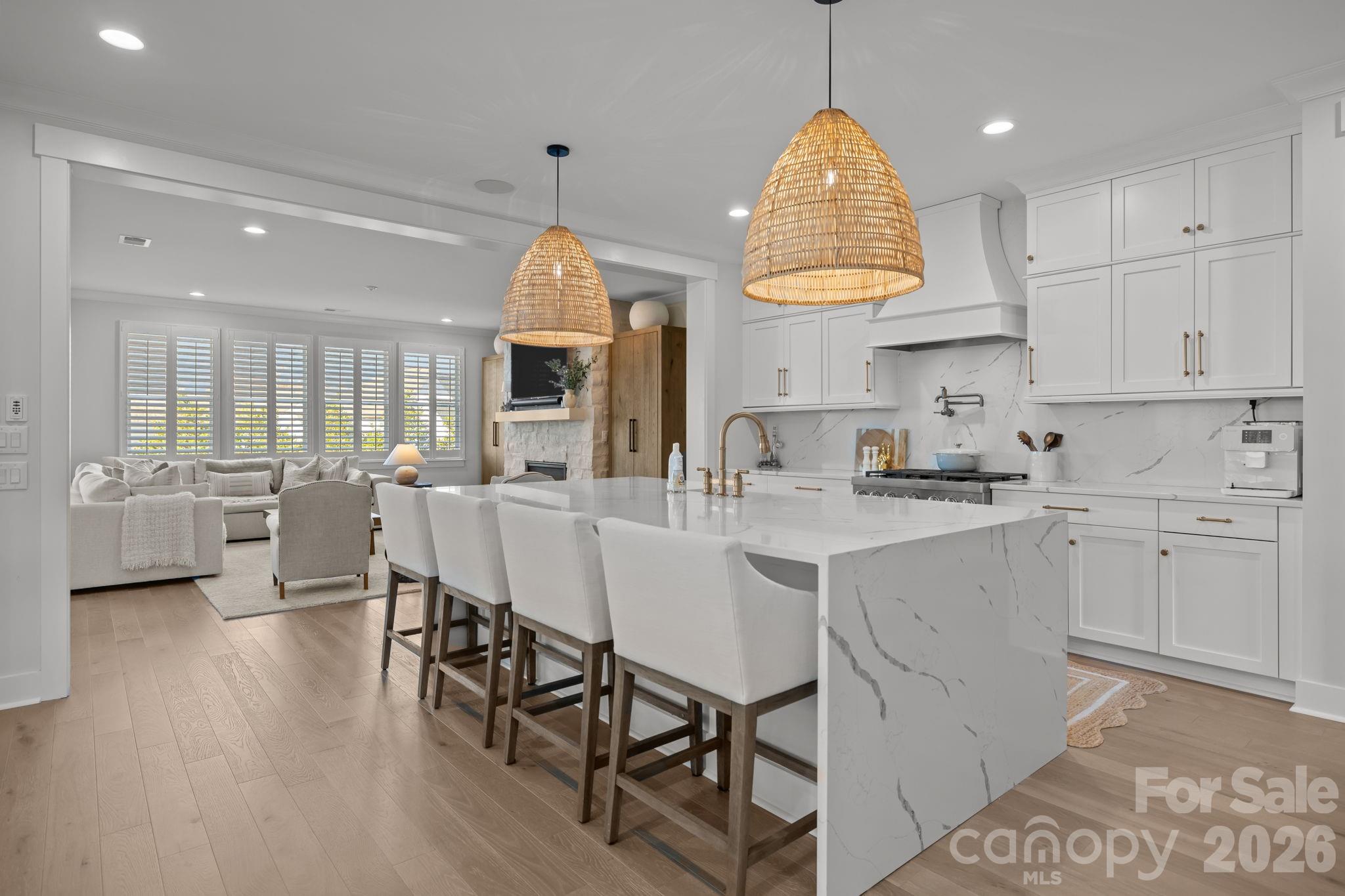 Step into modern luxury with this 2024 full brick home, where elevated design meets effortless, boho-inspired style. Offering 4 bedrooms and 4.5 baths, every space has been thoughtfully designed for both comfort and elevated everyday living.
At the heart of the home, the chef-inspired kitchen features quartz countertops, a striking waterfall-edge island, and an ideal layout for both casual meals and entertaining. The open-concept design flows seamlessly into the living area and out to the screened porch, where a multi-sliding door creates true indoor-outdoor living, perfect for morning coffee or evening gatherings.
Engineered wood floors span the main level, adding warmth and continuity throughout. The primary suite offers an elegant private retreat with a spa-like bath featuring a soaking tub, oversized walk-in shower, and a large walk-in closet. Additional bathrooms showcase elevated finishes, while the guest suite stands out with beautiful Carrera marble, creating a refined and welcoming space for family and visitors.
Designed with intention, this home perfectly balances luxury and function, where comfort meets style and every detail enhances daily living. Whether hosting or unwinding, you’ll appreciate the seamless blend of sophistication and livability.
Located in the highly sought-after Arden Mill community, this nearly new home offers the opportunity to start and end each day in comfort, style, and luxury.