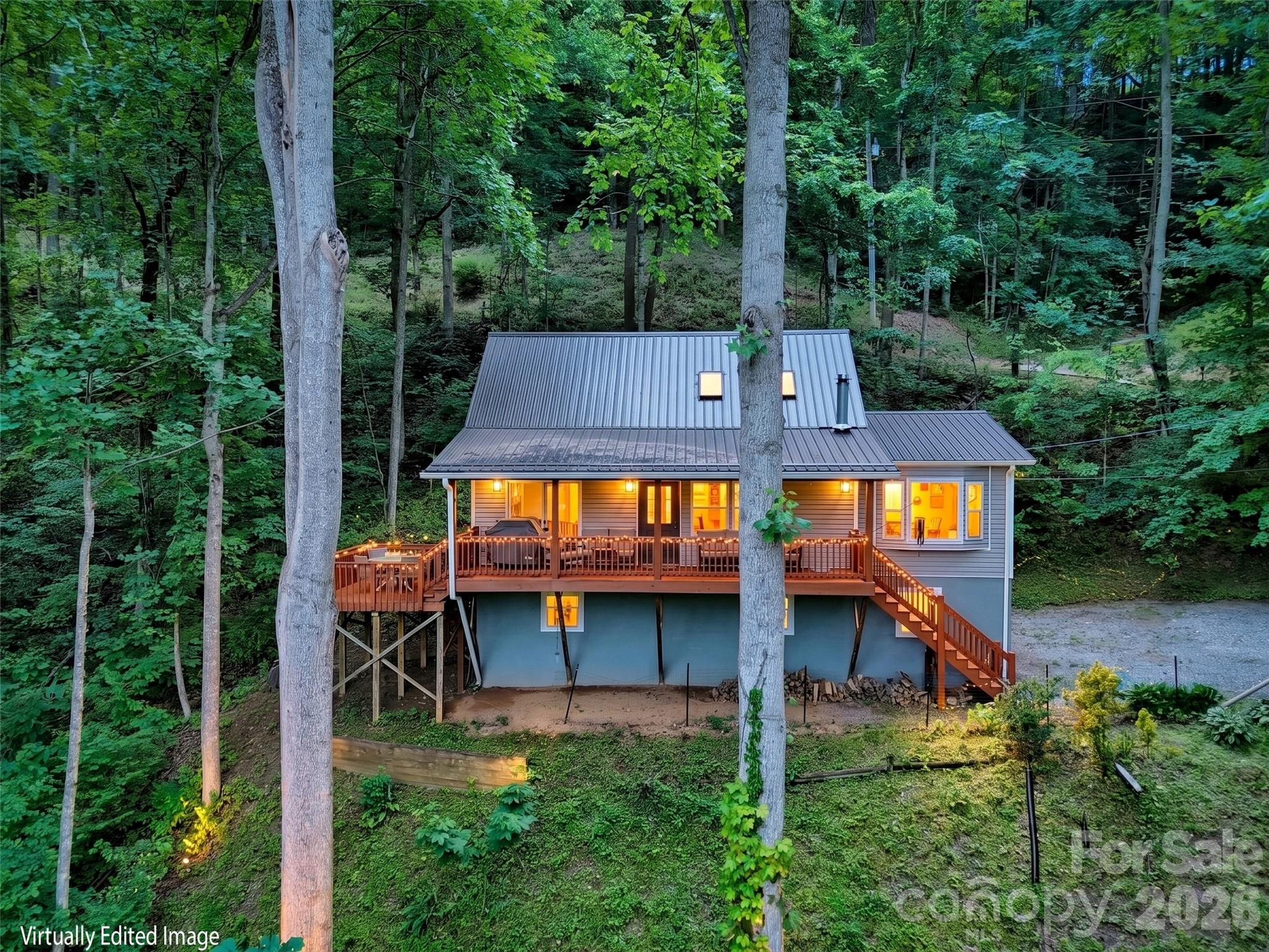 Come experience this beautifully updated mountain-view home in the desirable Maggie Valley Country Club Estates! Conveniently located just a short distance from the main entrance, this exceptional property is perched on two southwest-facing view lots, offering breathtaking year-round mountain views. The current owner purchased the adjoining lower lot and opened the view to the mountains. Thoughtfully renovated throughout, the home features a complete makeover, including the addition of an elevator for easy access between the basement and the main level. Interior improvements include new hardwood flooring throughout, hardwood ceiling accents, beautifully tiled bathrooms, an updated kitchen with granite countertops and quality appliances, custom closet systems on the main level, and a finished lower level transformed into a spacious studio-style suite complete with laundry, a full bath and walk-in closet. Outside, extensive landscaping enhancements include two French drains, a new retaining wall, and a gated driveway with ample parking and plenty of room to turn around and maneuver vehicles. The lower portion of the property has been fenced, creating a wonderful space for dogs, while a charming fire pit offers the perfect place to gather and enjoy cool mountain view evenings. A freshly stained deck provides the ideal setting to relax and take in the stunning scenery. Located just minutes from Maggie Valley, Waynesville, and all the area's attractions, this remarkable property combines a spectacular setting, quality updates, thoughtful amenities, and exceptional convenience. Beautifully maintained and move-in ready, it offers a rare opportunity for its next owner to enjoy mountain living at in one of the finest Golf Communities.