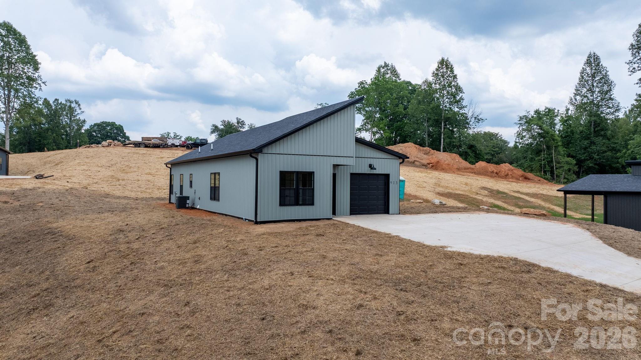This well-designed 3-bedroom, 2-bath home sits on 0.66 acres and offers beautiful year-round long-range mountain views paired with modern finishes throughout. The open concept layout feels bright and spacious, featuring tall vaulted ceilings in the living room and kitchen that enhance the home’s comfortable and inviting feel.

The kitchen is equipped with stainless steel appliances, quartz countertops, a tile backsplash, and a spacious island that anchors the main living area. The primary suite includes a walk-in tile shower and a generously sized walk-in closet, while both bathrooms feature large double quartz-top vanities that provide ample storage and counter space.

Outside, the elevated setting provides privacy and scenic views, while the concrete driveway offers ample parking space. No HOA and no subdivision restrictions, and a finished garage with plenty of storage. Conveniently located with access to Highway 321 nearby and positioned between Boone and Hickory, this property offers a peaceful setting with modern comfort and style.