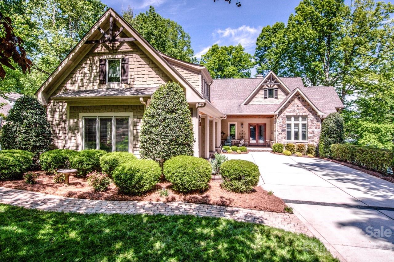 Stunning Retreat on Lake Norman! The custom finishes, details and trim work in this home are unique and gorgeous! Boasting vaulted ceilings, stone fireplaces, wood beams, coffered ceilings and more! As you enter the home bask in the beauty of the lake and the expanding views of Lake Norman State Park. The views from the home are lush and tranquil. Never to be built on! The outdoor space is spectacular with incredible and extensive stone work, outdoor kitchen and shower, dog run, fire pit and many levels for entertaining.  The dock is rare as it has 2 boat lifts (10K lb & 6K lb). It's covered with plenty of room for seating and entertaining. Many upgrades in this home. A list is provided in the media section. The kitchen has been renovated along with primary bathroom. New lighting, fans, and paint! There is a 2nd living quarters on the bsmt level with a separate entrance. Jet Ski Lifts do not convey.