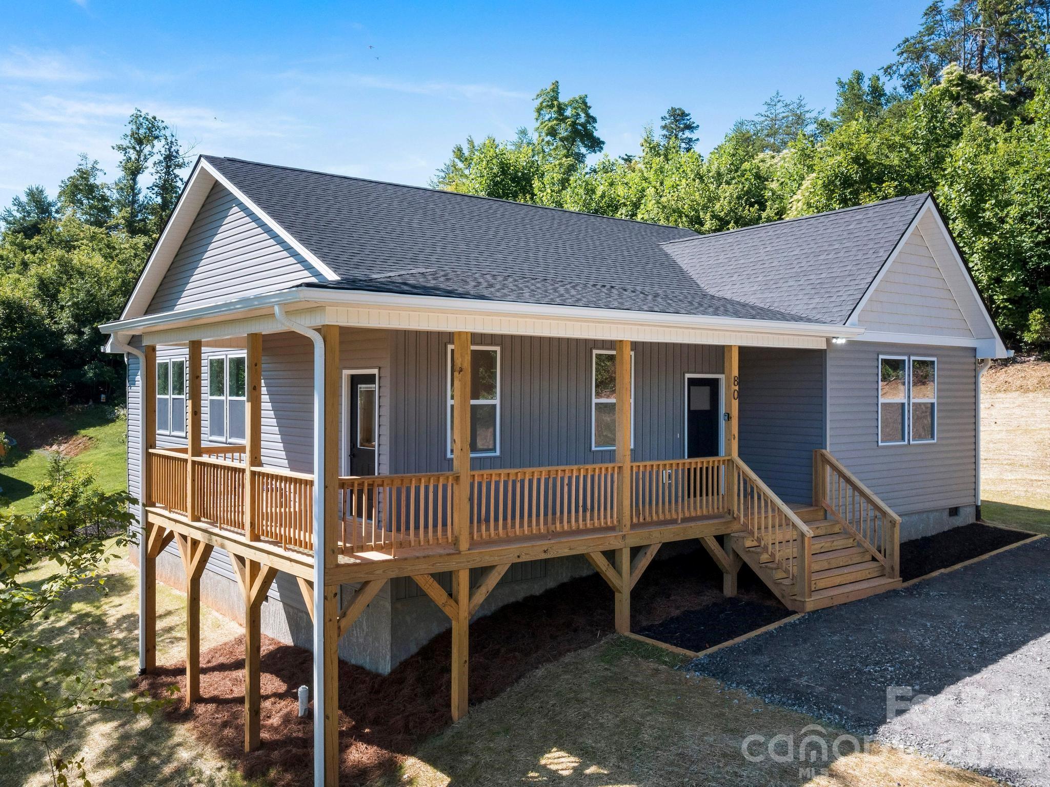 Brand new construction with mountain views just 5 minutes from I-40 and downtown Old Fort’s breweries, restaurants, and shops. Nestled atop a gently sloping lot lot for added privacy and the perfect view. This one-level home offers a peaceful setting with great usable yard space—perfect for gardening, relaxing, pets, or play. Enjoy outdoor living on the large covered rear deck, an ideal spot to unwind and take in the views. Inside, thoughtful details shine with arched entryway, shaker cabinets, a contrasting kitchen island, spacious pantry, custom closet shelving, and hall laundry room. The primary suite features a large walk-in closet and ensuite bath with custom tile shower. Two guest rooms and a full hall bath offer plenty of space. Convenient to Catawba Falls, 15 minutes to Black Mountain, 30 minutes to Asheville, and 40 minutes to Lake James. STRs allowed.