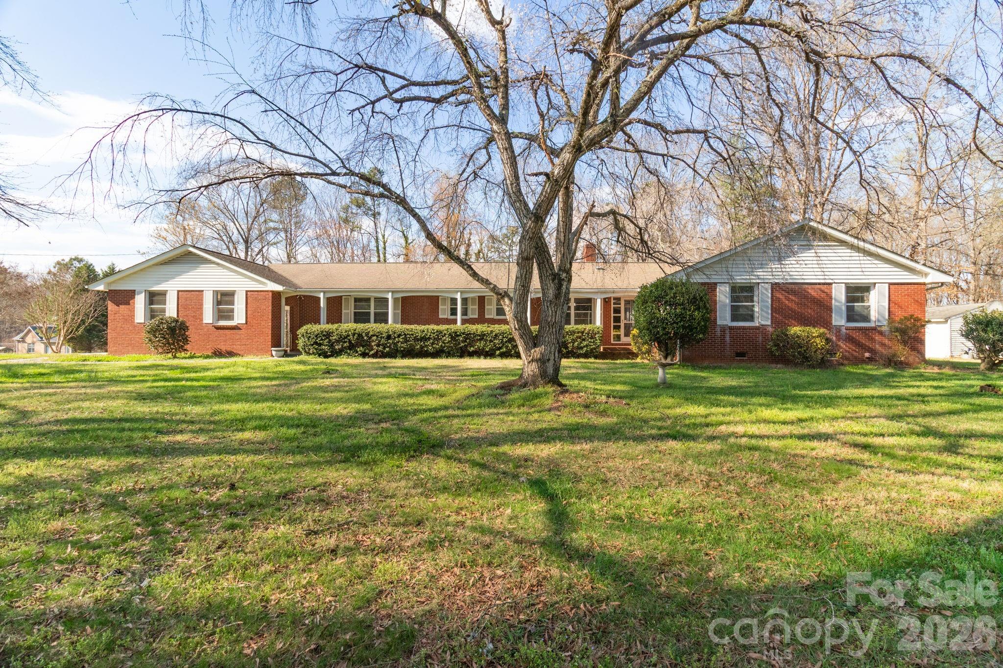Classic brick ranch set on a spacious corner lot offering 1.62 acres of room to spread out and enjoy the outdoors. This inviting property features three fireplaces that add warmth and character to multiple living areas, creating comfortable spaces for relaxing or entertaining. The layout provides flexibility for everyday living while maintaining the timeless appeal of ranch-style design. Outside, the large lot offers endless possibilities for gardening, recreation, or simply enjoying the open setting. Ample driveway parking provides convenience for multiple vehicles and guests in addition to the 2-car attached carport. With its combination of land, charm, and practical features, this property presents a wonderful opportunity to enjoy peaceful surroundings while still being within easy reach of nearby amenities, dining, and shopping. A rare chance to own a home with generous acreage, classic brick construction, and distinctive features that make it truly stand out.