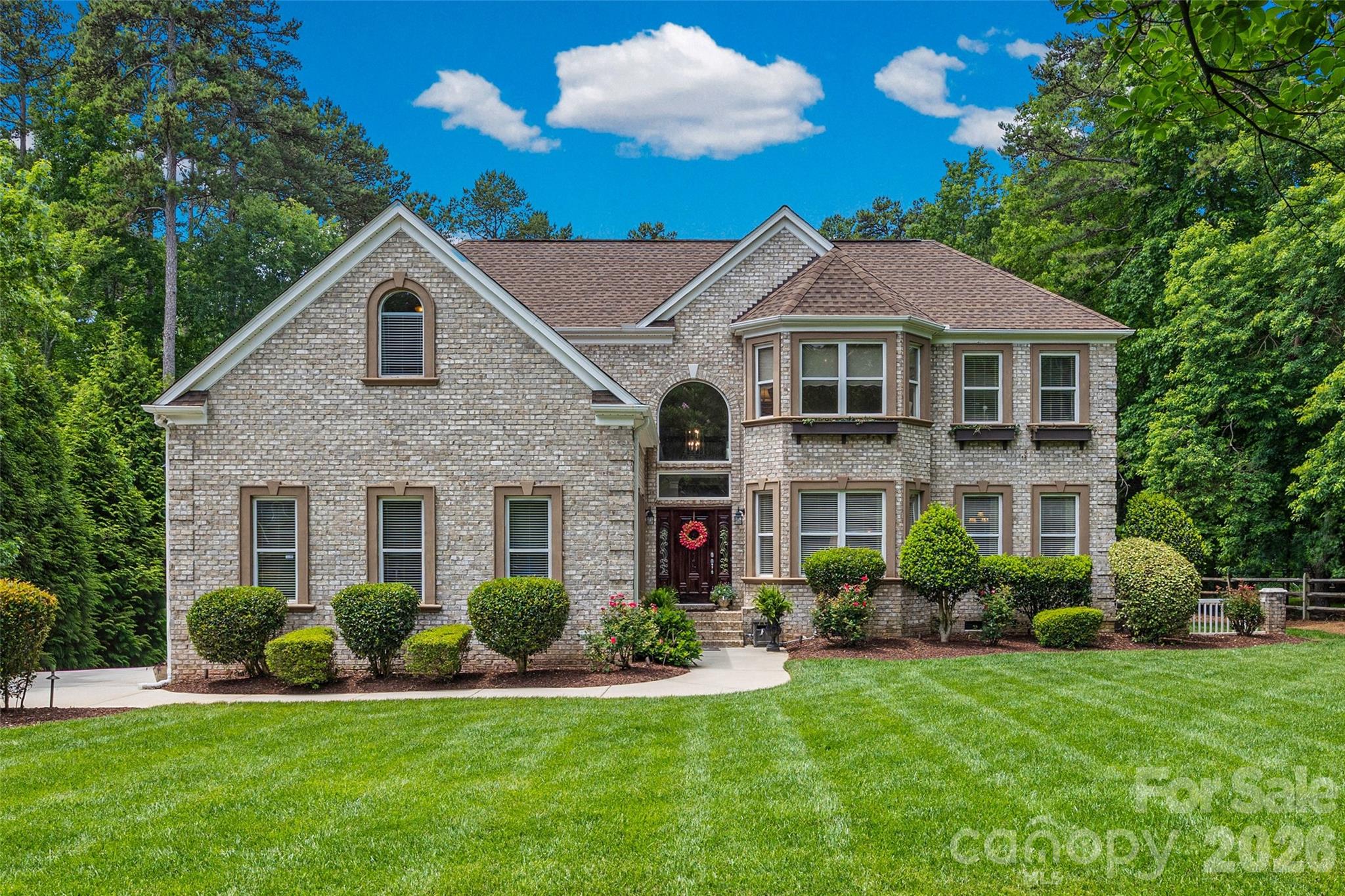 If you are looking for space to breathe without sacrificing thoughtful, high-end design or close proximity to Charlotte, this full-brick Mint Hill home delivers it all. Tucked away in an established neighborhood known for its mature tree canopy, this property sits on a hard-to-find flat, private one-acre lot that feels like your own personal park. The home has been exceptionally well-maintained and its craftsmanship stands out immediately. Step inside to find soaring ceilings and extra-tall custom doorways, originally designed to accomodate a professional athlete, which gives the entire main level a bright, lofty feel. The real showstoppers, though, are the custom hardwood floors with detailed inlays that run seamlessly through the main living areas and the dramatic, thick-profile crown molding throughout.

The layout is incredibly functional, featuring a highly sought-after first-floor primary suite. It serves as a quiet, sunlit sanctuary, complete with a generous walk-in closet outfitted with custom built-ins and an en-suite inclusive of a large soaking tub.  Upstairs, you'll find a spacious guest suite with its private bathroom and flex space currently being used as a gym, as well as the additional bedrooms.

While the interior of this home is undeniable luxury, the true showstopper is the backyard oasis. Backing up to a dense, tranquil hardwood canopy and fully enclosed by a rare, eight-foot privacy fence, this outdoor space offers an unparalleled level of seclusion. It is a masterclass in Carolinas lifestyle design. Spend vibrant summer days lounging poolside by the sparkling in-ground pool, or gather around the custom fire pit for crisp autumn evenings. The expansive covered rear porch serves as an elegant extension of the home, perfect for your morning espresso or al fresco dinner parties. This space is so spectacular it has even served as a private wedding venue, complete with a five-piece band on the porch and guests dancing poolside under the stars.

Rarely does a property seamlessly bridge the gap between unrestricted privacy and urban accessibility. Boasting a coveted three-car garage and the absolute freedom of no HOA restrictions, this estate caters perfectly to car enthusiasts, hobbyists, or those simply seeking a relaxed, unconfined lifestyle. Nestled in a prime location, you are just a short drive from the charming local spots, boutiques, and eateries of Mint Hill, while the world-class dining, sports venues, and energy of Uptown Charlotte are just minutes away. In a rapidly growing market, finding a property that offers this level of autonomy, space, and proximity to the city is increasingly hard to find, making this home a true crown jewel of the Queen City suburbs.