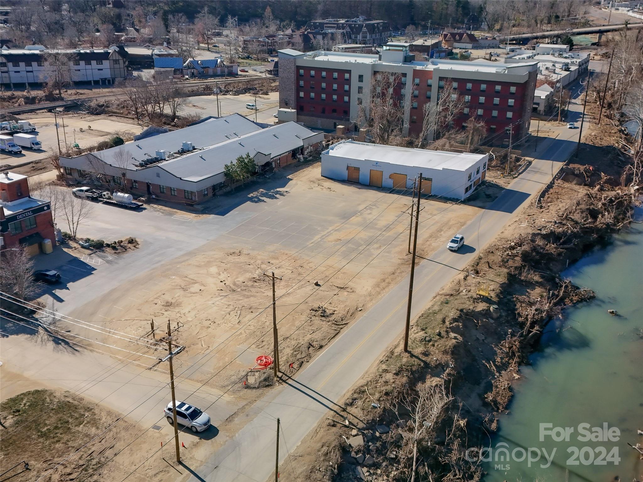 Introducing 71 Thompson St, Asheville, NC, a +/- .93-acre redevelopment opportunity in the heart of Biltmore Village, heavily impacted by hurricane Helene, and ready for new, creative redevelopment vision. This 5-parcel assemblage is located with the River zoning district, as well as the "All" hotel overlay district, making for a unique redevelopment opportunity in a central Biltmore Village location.  With over 300 feet of road frontage on Thompson Street, easy access to downtown Asheville, and walking distance to the Biltmore estate, this expansive property offers an exceptional opportunity for investors looking to lead the charge in bringing new life and creative redevelopment into the core of Biltmore Villages post Helene recovery.