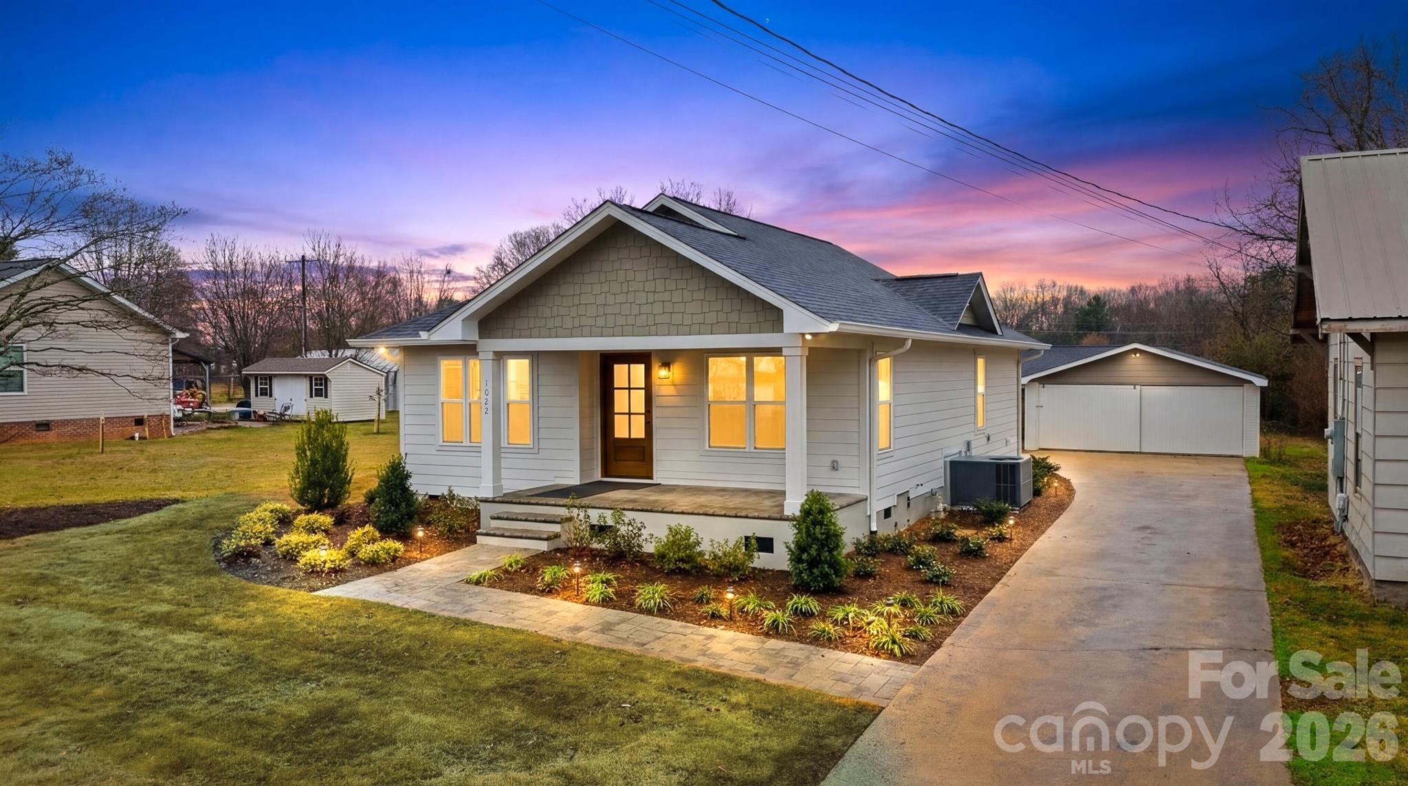 Completely rebuilt from the ground up, this beautifully finished 2 bedroom, 2 bath home offers the charm of an established area with the peace of mind of nearly all new construction. The home was reconstructed with new framing, new foundation work, all new electrical and plumbing systems, new windows, and high-quality finishes throughout.

Inside you’ll find custom cabinetry, quartz countertops throughout, solid wood interior doors, tile bathrooms, a beautiful glass shower in the primary suite, and a farmhouse kitchen sink with matching new appliances. Additional upgrades include recessed lighting, custom closet systems, pantry shelving, a laundry room sink, and a tankless-style constant hot water system.

Outside, enjoy a professionally landscaped yard with Bermuda sod, drip irrigation for the flower beds, and a paver walkway leading to a spacious backyard patio with built-in fire pit — perfect for entertaining. Underground power adds to the clean exterior aesthetic.

The property also includes a detached garage/workshop providing excellent storage or hobby space.

This home combines modern construction, thoughtful design, and outdoor living in a convenient Maiden location.