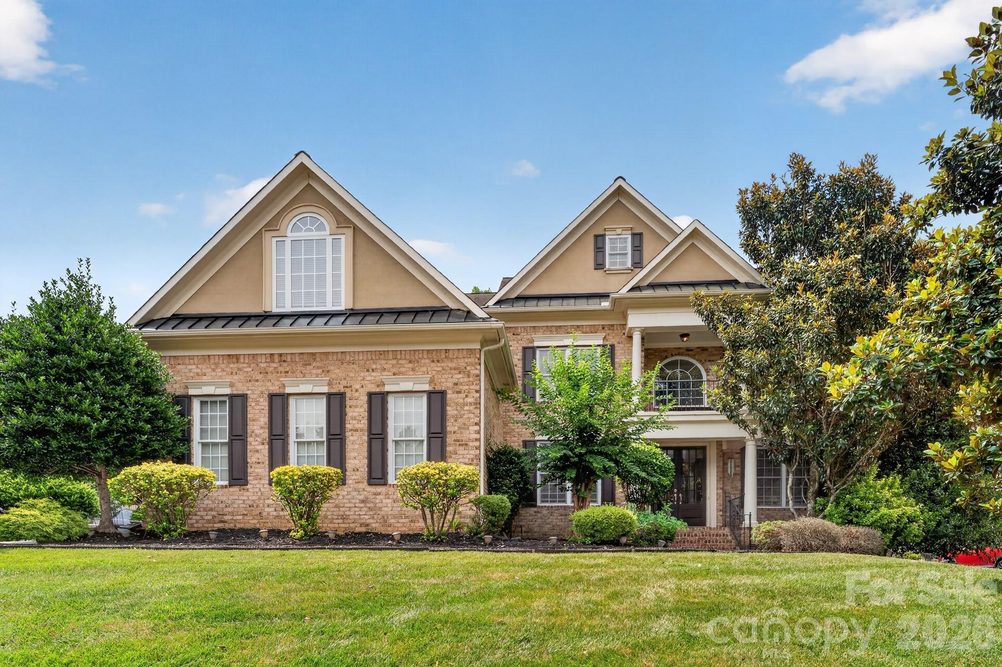 Brick front John Wieland home in sought after Bridgemill, offering 5BR/4.5BA, roughly 4,455 sqft, and a 3 car garage on a private fenced lot with a heated Pebble Tec pool and spa with waterfall. The soaring two story great room features a wall of windows, gas fireplace, and built ins over rich hardwood floors. The chef's kitchen shines with 42" cabinets, quartz counters, gas cooktop, double ovens, and an island bar, opening to a sunny breakfast bay and keeping room with fireplace. A main level office and guest suite with full bath add flexibility. The oversized primary retreat boasts a sitting room, flex or gym space, and a renovated spa style bath. Every bedroom enjoys direct bath access, and the third floor adds a media and bonus room. Designer moldings and wainscoting flow throughout, with resort style outdoor living under a pergola. Enjoy Bridgemill's clubhouse, fitness center, pools, tennis, dog park, and trails, minutes to Ballantyne with low Lancaster County taxes!