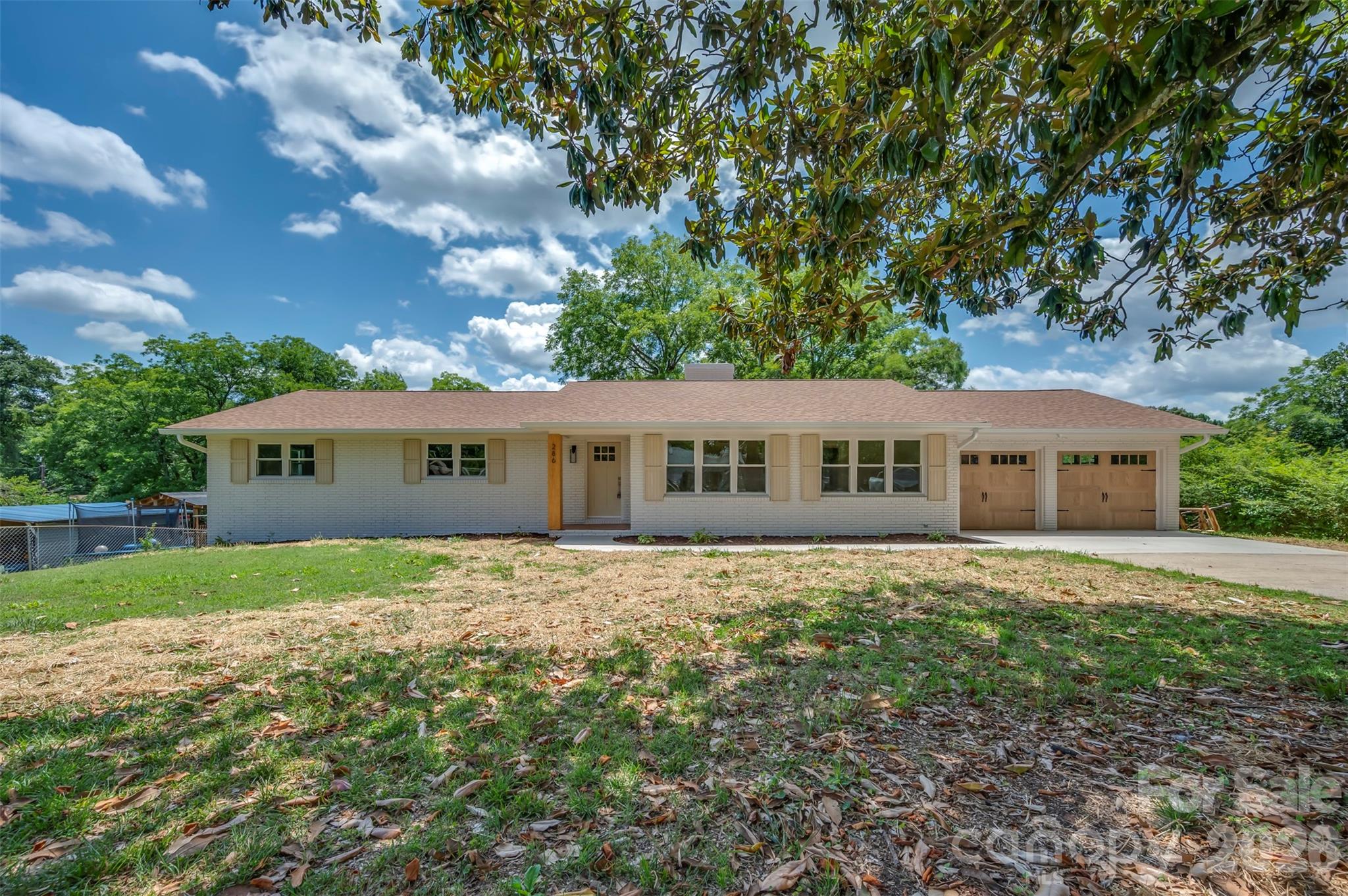 Sleek lines and warm tones make this renovated ranch a standout HOT listing presenting the one-two punch of curb appeal and affordability.  Stunning outside and gorgeous inside with engineered hardwood floors, custom-built cabinetry, and beautiful granite countertops.  The neutral paint selections on the walls & trim blend seamlessly with the soft tones of the oak floors.  Huge living room flows into the pass-through kitchen with lovely shaker cabinetry to the ceiling and herringbone tile backsplash.  Just off the kitchen to the right you'll find a laundry/mudroom entrance with an adorable covered stoop leading to the back yard.  Adjacent to the kitchen is a spacious dining room/family room w/wood-burning fireplace and sliding door to the rear terrace - the perfect spot for that pizza oven and grill station or outdoor dining space.  Primary bedroom w/generous walk-in closet & full tile shower.  All new windows & HVAC, new lighting & plumbing, and new doors.  All updates permitted & inspected w/public water through Broad River Water Authority.  Such a quaint, endearing home without worry of needed repairs or renovations - totally MOVE-IN READY and priced to sell!!