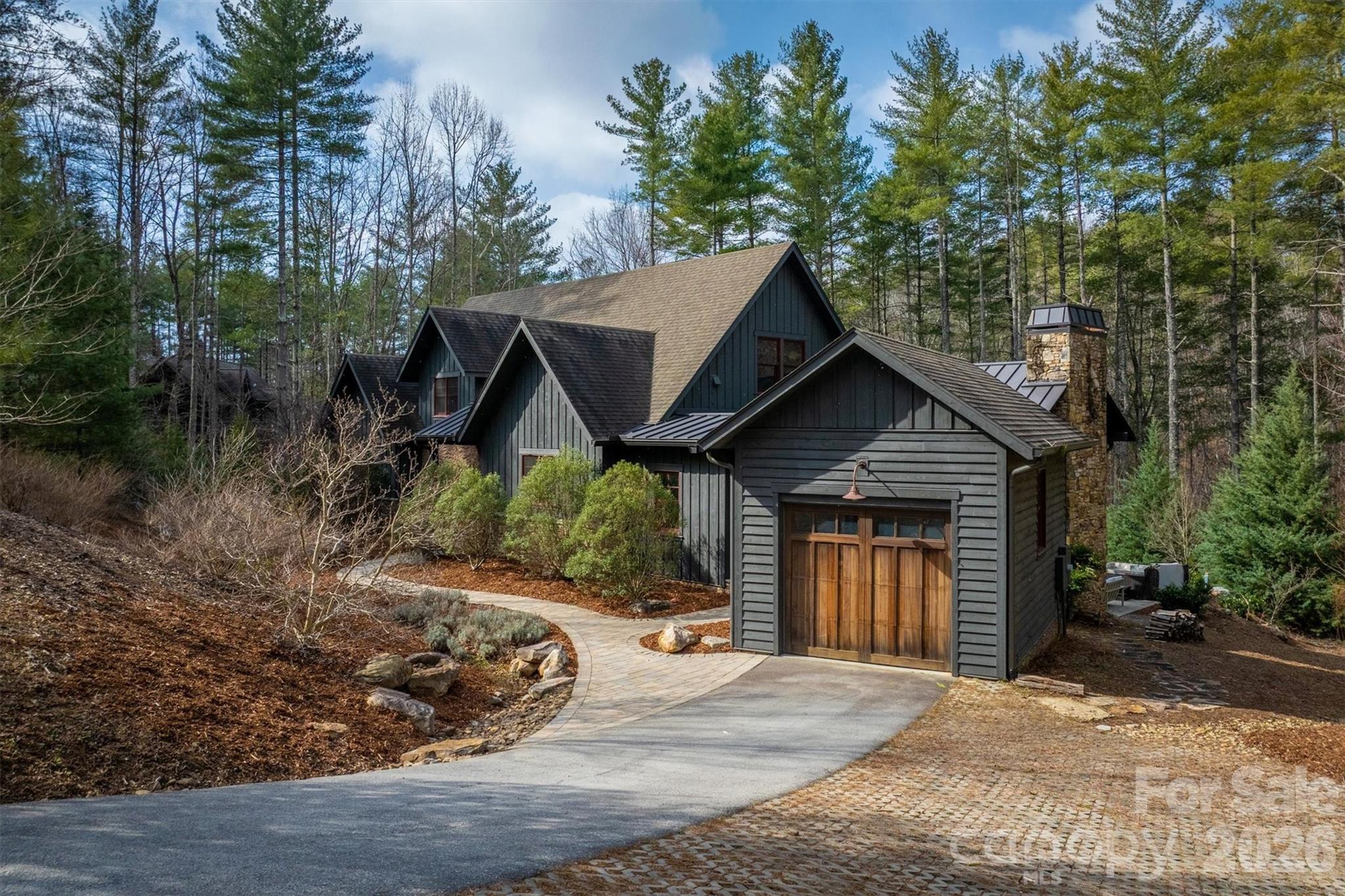 Timeless craftsmanship blended with gracious Lake James community living—that’s how we describe this home. The setting is wooded and private, near the 1780 Community pond and the trails of Hully Gully, which allow you to walk down to the lakeshore or Camp Lake James in minutes. This spacious home is functional for full-time living, but it’s also allowed to be a short term rental with significant income potential.  It has a large kitchen with custom cabinetry, gas range, wine cooler, granite countertops and a large quartzite island. The downstairs living area has wide-planked hardwood floors and a stone fireplace with vented gas logs, custom bookcases and arts and crafts style details.  The living area also leads to a custom screened porch with cathedral tongue and groove ceiling, wood fireplace and stone chimney.  A charming reading nook under the staircase provides a peaceful escape, while also serving as a twin bed for a guest. The extra large primary bedroom suite has hardwood floors that flow into a private sunroom. It includes a private deck and a walk-in closet.  The primary bathroom has tile floor, walk-in tile shower, water closet, independent sink vanities with granite tops and  custom drawers for linens and towels. Upstairs, you’ll find two large bedrooms separated by a cozy media den and a jack and jill bathroom. Each bedroom has two built-in twin beds and is also roomy enough for a king-sized bed. Spacious floored attic space is accessible through the bedrooms on both sides of the house.  The front door entryway has a slate floor and a powder room.  The breezeway entry is through a long tiled mudroom, which includes laundry, pantry, hall closet and storage room/kennel with a dog access door. The stone breezeway has a tiled outdoor shower and leads to the garage. The back of the house has a yard surrounded by woods with a quiet lounging/exercise platform and a large patio with a hot tub. The house has a sealed crawl space, only one owner and has never been rented. It also comes with a boat slip on the Patton Docks. Ownership in 1780 includes membership to Camp Lake James and its amazing amenities and community events.  Amenities include restaurant, fitness center. kids pool and junior olympic size pool, hot tub, tennis, pickleball, beach with paddle boards and kayaks, docks, and outdoor bar.  Check out Camplakejames.com.