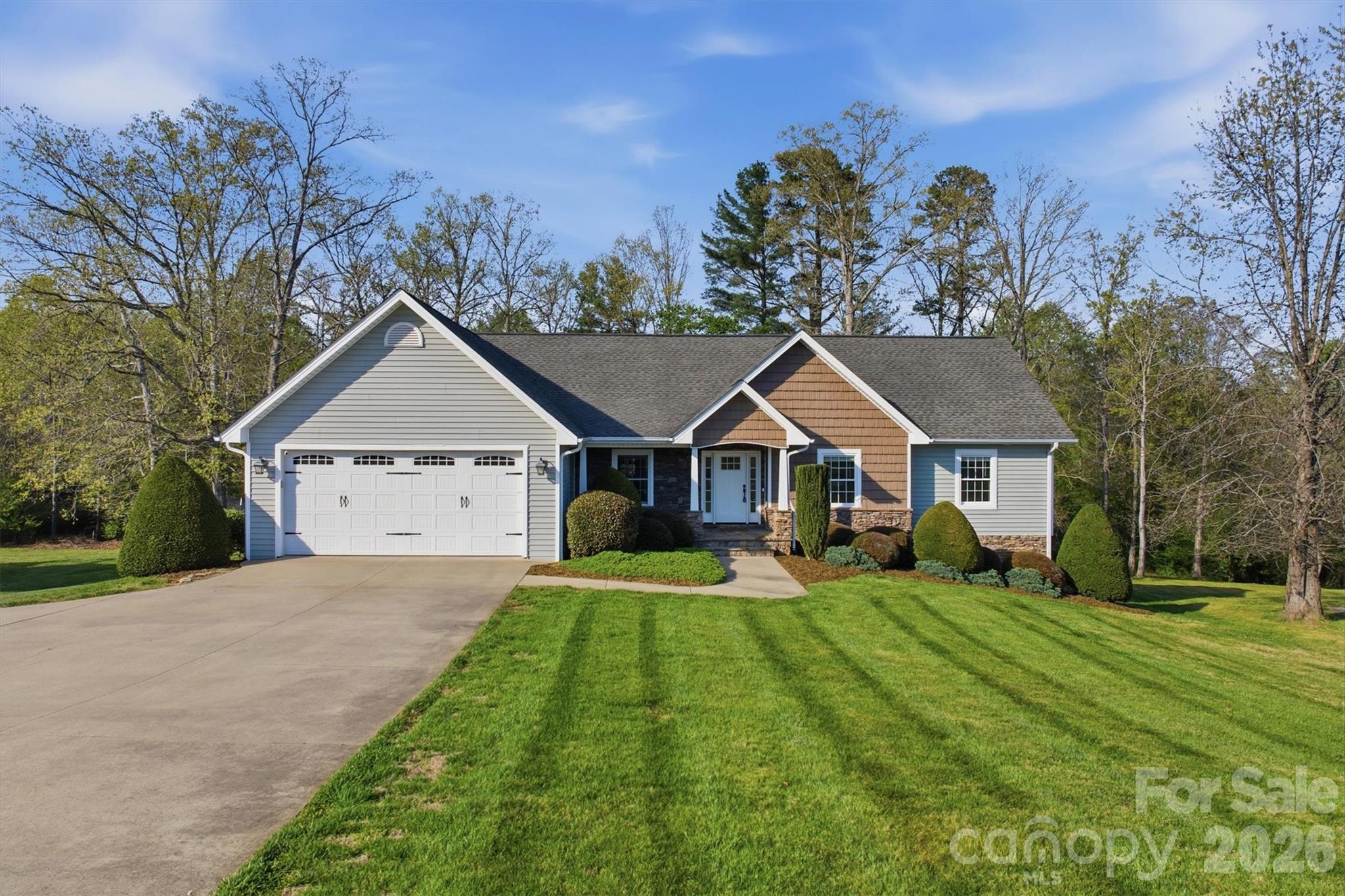 This beautiful ranch-style home in the desirable Twin Oaks Subdivision offers the perfect blend of spacious living and functional design. Boasting nearly 3,300 square feet of finished space, this 4-bedroom, 3-full bath residence provides ample room for both daily life and hosting guests. The open-concept main floor features stunning hardwood floors, formal dinning, and a vaulted living room anchored by a cozy stone fireplace. Bright and airy Chelf kitchen with timeless white cabinetry, granite countertops, breakfast nook, and a central island—perfect for morning routines or meal prep. The kitchen flows seamlessly into a charming sunroom providing a light filled spot for morning coffee or casual dining, while overlooking the back yard. Enjoy a peaceful retreat to the Primary suite, with a tray ceiling and luxurious ensuite bath featuring a soaking jet tub, separate walk-in shower, dual vanities, and walk-in closet. The expansive lower level includes a large recreation room—ideal for a pool table, media center, 4th bedroom, etc—plus additional living quarters, full bath, and walk-in closet. 
  Garages Galore: This property is a rare find with a 2-car attached garage on the main level and an additional single-car garage in the basement, perfect for a workshop, boat storage, or a classic car.  Additional storage, or workshop space, on opposite end of home. Relax on the oversized back deck overlooking a nice flat backyard, offering plenty of space for play or gardening. Nestled in the heart of Granite Falls, you are perfectly positioned for convenience: Minutes from Downtown Granite Falls and local shopping, a short drive to the lake for weekend recreation, and easy access to Hickory for dining, medical facilities, and entertainment galore. Don't miss your chance to own this versatile and well-maintained home in one of the area's favorite neighborhoods!
