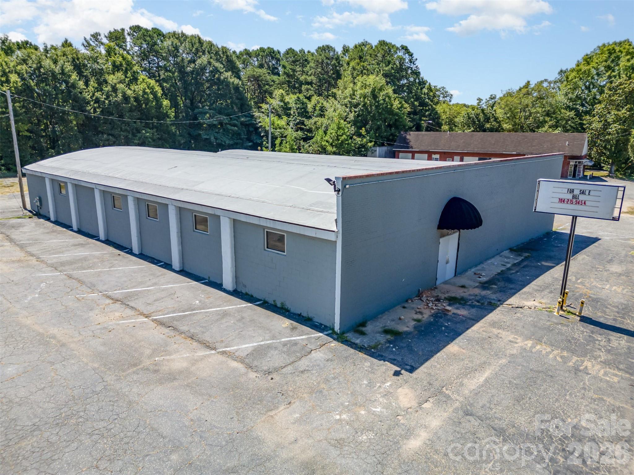 Located on a high-visibility corner lot in Gastonia, this 8,000 sq ft commercial building offers a wide-open layout and major recent upgrades including a new roof, updated HVAC, and new plumbing. The freshly renovated interior features soaring exposed steel trusses, polished concrete floors, and bright overhead lighting—making it ideal for warehouse, light industrial, retail, or creative use. Multiple entry points and ample parking provide flexibility and ease of access, while the clean, modern exterior and street frontage offer excellent signage potential. With its move-in-ready condition and versatile zoning, this property is a standout opportunity for your next business venture!