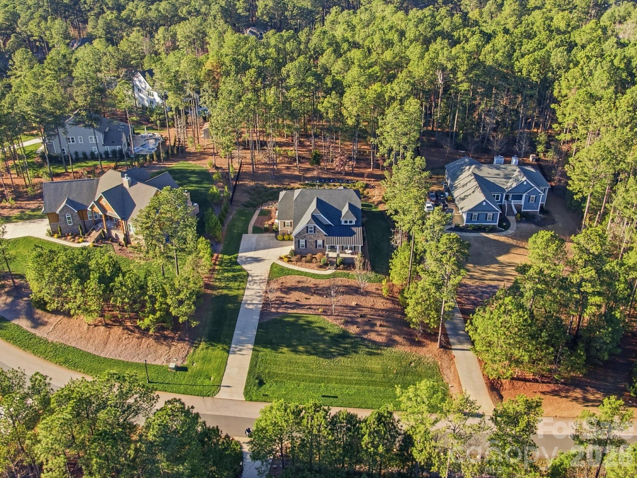 This is one of the most stunning and meticulously maintained homes you'll find! Avoid waiting 12 months to build and spending thousands more when this one looks like new construction! Plus you'll already have these additional upgrades in place for far less than if you have to add them to new construction after: an encapsulated crawlspace with dehumidifier, whole-house generator, whole house surge protector, tankless water heater, vinyl windows in your 3 season room & so much more! Gorgeous wide plank floors throughout, beautiful light fixtures and lots of trim work. Natural light fills every room! The primary suite is located on the main floor and features a spa-like bathroom with a huge walk-in shower. An additional bedroom and full bath on the main floor is ideal for guests or office space. A spacious dining room. Impressive kitchen with a spacious island, gas cooktop, new oven/microwave, farmhouse sink, quartz counters and open flow into the great room with stacked stone fireplace. A laundry room you can enjoy with cabinets, stylish tile floors & counterspace to fold.  Upstairs another bedroom, full bath, a loft and storage! Three season room is perfect for morning coffee or an evening glass of wine complete with vinyl windows that you can open or close to enjoy the porch year round. Step outside to the flat patio, perfect for grilling and enjoying an afternoon barbecue. Beyond the patio, a stone path leads to a large upper flat yard area with endless potential for a future pool, fire pit, playground, garden, or additional outdoor living space. Extended driveway apron for multiple car parking and turnaround space. Riverchase Estates offers a luxury lifestyle with lower Lancaster County taxes and resort-style amenities including Catawba River access, clubhouse, fitness center, pool, sports courts, playground, trails, and a 500-acre nature preserve. The area continues to see tremendous growth with shopping, dining, grocery stores, and conveniences including Costco and Target all within about 15 minutes. 10 year transferrable warranty.