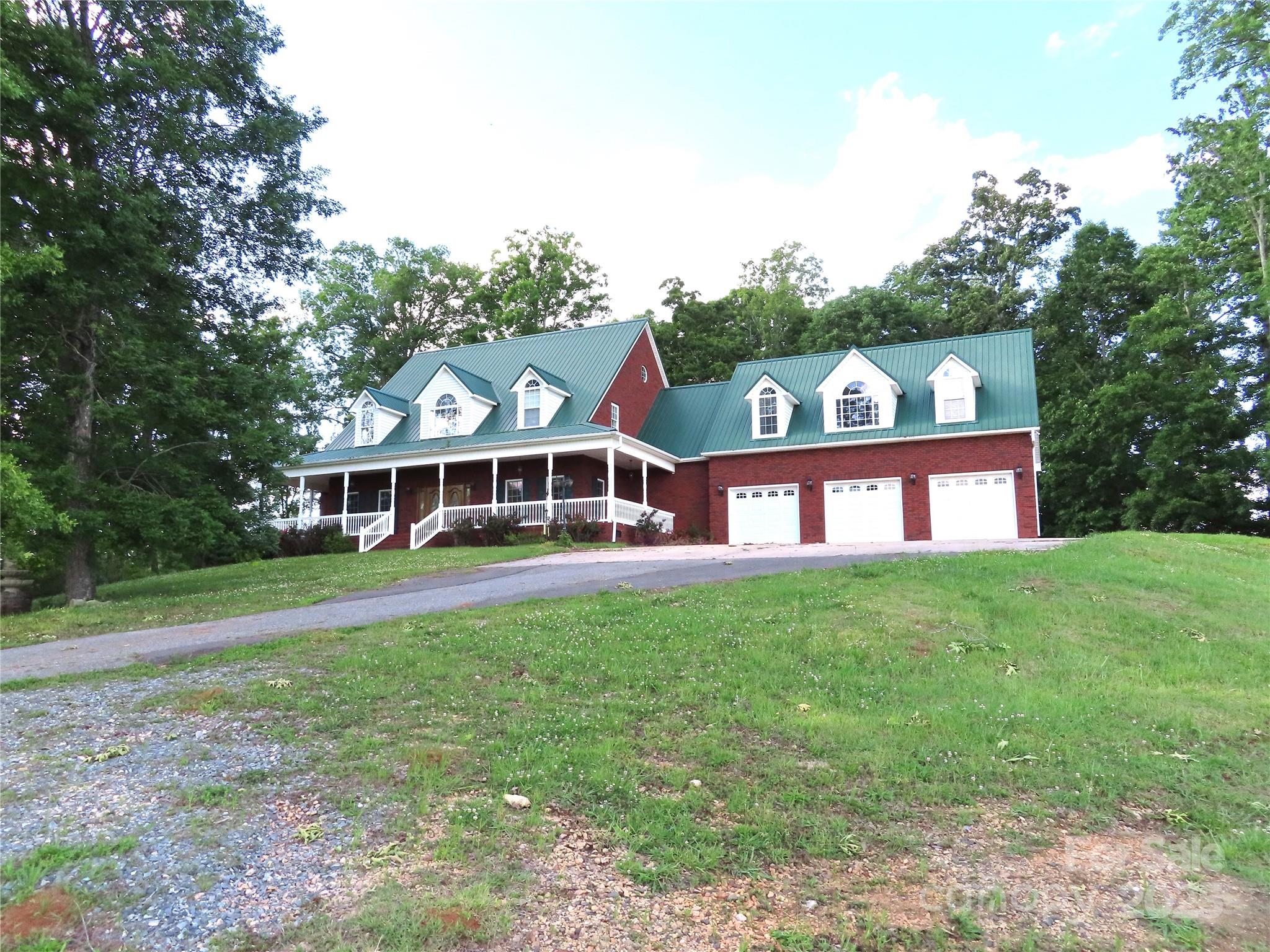 Sitting perched up on a hill for magnificent views and located only 7 miles to York. Needing Space? This one has it! 
This all brick home with 4867 heated square feet, all wood and tile flooring with the primary bathroom tile floor being heated, the main floor has the primary bedroom and a guest bedroom & bath . The upstairs has 3 bedrooms and 2 more baths & a bonus room. Home also has a 3 car attached garage.There is a barn & a covered shed. Bring the horses, cattle and your four wheelers. Plenty of room to enjoy nature, plant a garden and more! The pond is not located on the property but the view is great!