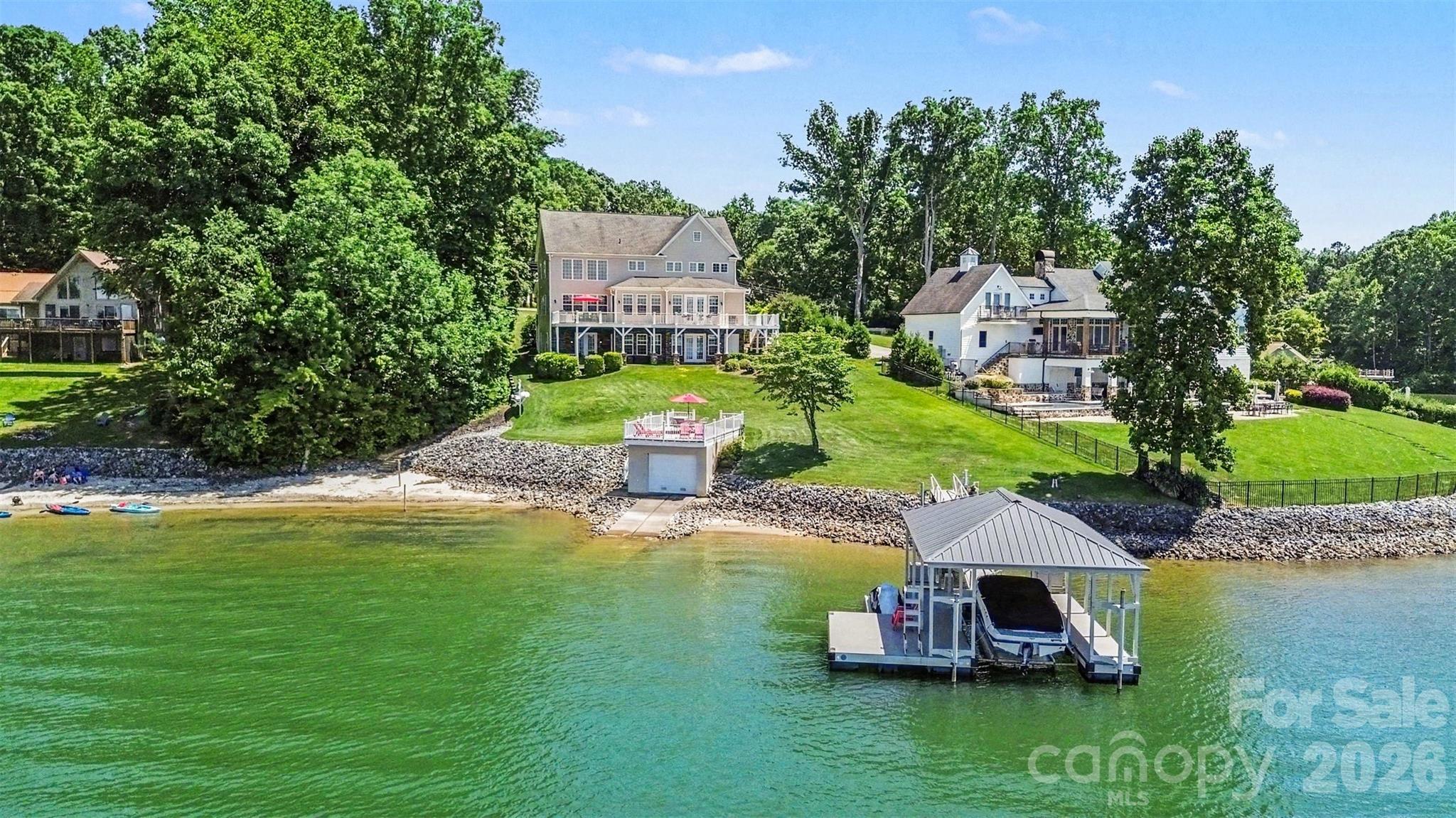 With sweeping open-water views, a private beach, and an incredible boathouse, 678 Normandy Road delivers the kind of Lake Norman lifestyle buyers are searching for.

The boathouse features a rooftop deck that's perfect for entertaining, watching sunsets, or simply taking in the views. A newly covered, all-aluminum, maintenance-free dock by Floatation Inc. includes a 6,500-pound boat lift. The private beach is a great spot for swimming, kayaking, or relaxing by the water.

This home offers 5,300± square feet of thoughtfully designed living space. The main-level primary suite provides privacy, convenience, and beautiful lake views. The open floor plan connects the living, dining, and kitchen areas, with large windows throughout that keep the water front and center.

The walkout basement adds tremendous flexibility, featuring a second kitchen and private guest suite — ideal for visitors, extended family, or multi-generational living. The large theater room creates a private cinematic space for movie night or that special game. 

Whether you're looking for a full-time residence or a weekend retreat, 678 Normandy Road combines a hard-to-find waterfront setting with the space, privacy, and amenities that make living on Lake Norman living so special.