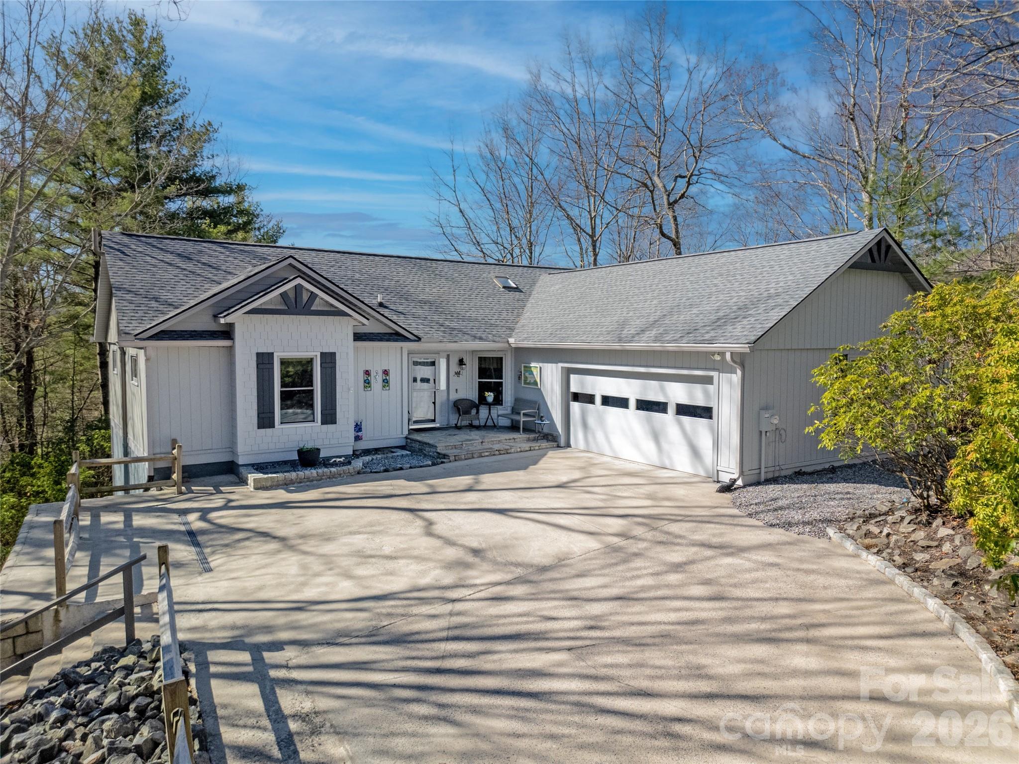 Located in the highly desirable community of Connestee Falls, discover the perfect blend of comfort and natural beauty in this charming 3-bedroom, 2-bath single-level home with mountain views. Designed for easy living, this home features a spacious, open layout with abundant natural light and seamless indoor-outdoor flow. Enjoy  year round mountain views and privacy from the great room, the expansive sunroom or while relaxing on the private deck — an ideal setting for morning coffee or evening sunsets. The well-appointed kitchen & baths, cozy living spaces, and generously sized bedrooms make this home both functional and inviting. Nestled in the serene, amenity-rich community of Connestee Falls, this property offers not just a home, but a peaceful mountain lifestyle. Expect such upgrades as: high-end granite tops, black, stainless appliances, updated plumbing, new deck with cable railing, whole-house generator, easy driveway into a pristine 2-car garage.  Some unexpected upgrades delivered are radon mitigation, pristine, encapsulated crawl space, engineered & enhanced retention walls & new windows. This home is spotless & beautifully maintained and updated, schedule a showing and see for yourself.  See attachments for full list of upgrades. Residents new to Connestee pay a one-time amenity fee of $14,000 at closing to enjoy such amenities as:  a clubhouse with 2 restaurants, lounge & pro shop, 18-hole golf course, state-of-the-art fitness center, 4 lakes, tennis, pickle ball, bocce, swimming pool & miles of hiking trails.