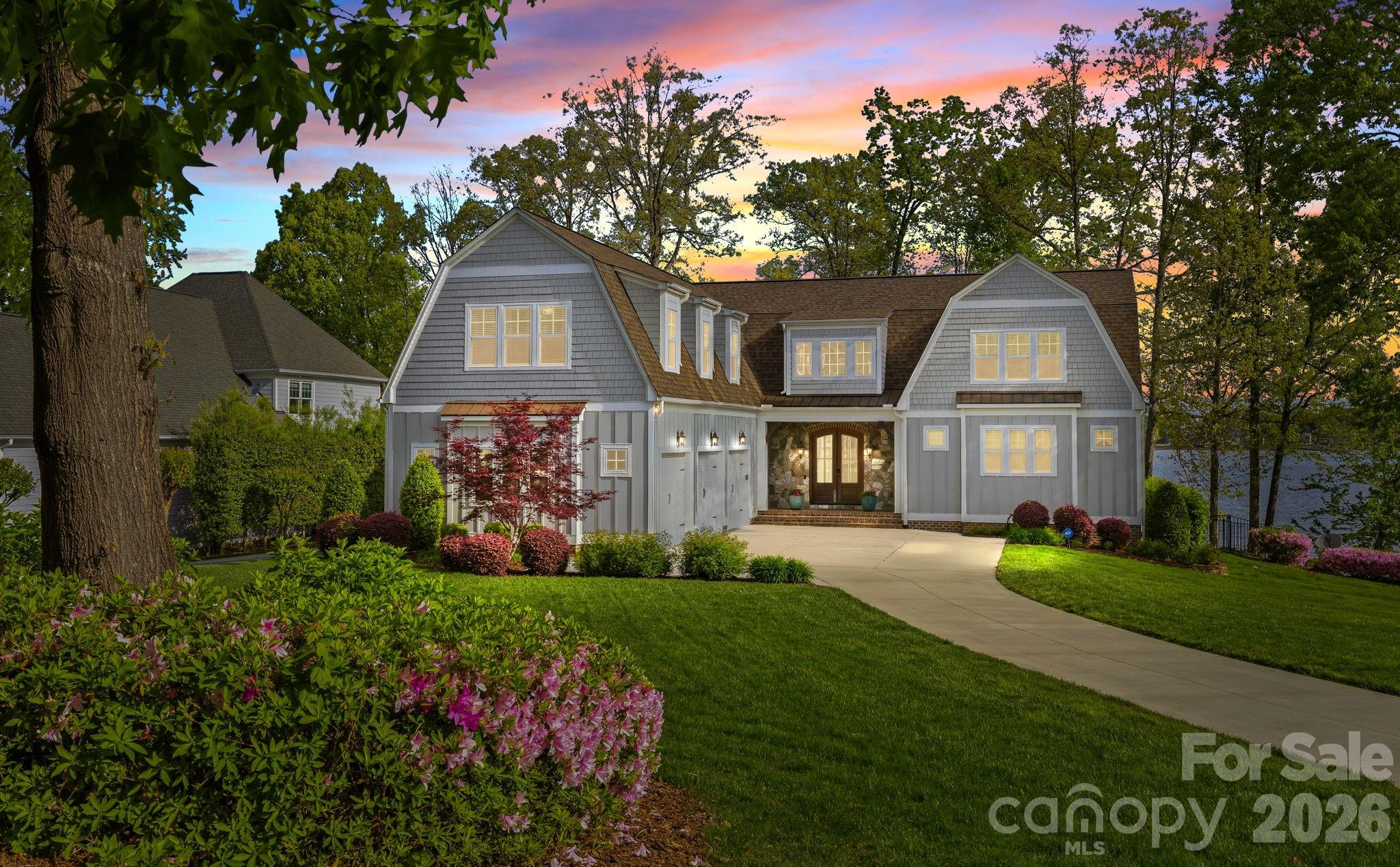 Welcome to your private lakeside oasis in the gated community of Pointe Regatta, situated on a premium stretch of Lake Norman with wide, unobstructed water views. Designed for effortless lake living and entertaining, this exceptional waterfront property showcases a resort-style outdoor living experience – complete with a stunning pool, spa, firepit area, and a covered outdoor patio with gas fireplace. Surrounded by mature trees that provide natural privacy from neighbors, this home offers both exclusivity and convenience, along with access to community boat slips, including an HOA-assigned slip just a short walk away that transfers with the sale. Seamlessly blending indoor and outdoor living, the home is filled with natural light and thoughtfully positioned to capture lake views from nearly every room. The main living area features vaulted ceilings with wood beams, a gas log fireplace, and expansive windows. The open-concept kitchen is designed for both everyday living and entertaining, offering a large island with seating, built-in wine cooler and icemaker, and a spacious pantry. The luxurious primary suite on the main level is a true retreat, featuring a Bainultra therapeutic spa tub, floor-to-ceiling walk-in shower, dual vanities, and generous his-and-hers walk-in closets. Throughout the home, you’ll find turnkey, high-end finishes, built-in cabinetry, a mudroom, and a large laundry room with extensive storage. Upstairs, all bedrooms include en-suite baths with decorative tile, along with a Home Office featuring a private balcony with lake views as well as a large bonus/flex space above the three-car garage. The outdoor living and entertaining experience is unmatched: step outside to enjoy the pool, hot tub, and expansive deck overlooking the water, or launch a kayak or paddleboard from your own shoreline access. A full bathroom accessible from the exterior provides added convenience for pool and lake days, allowing guests to shower and refresh without entering the home. With approximately 200 feet of shoreline, a fenced back yard, and a fully conditioned, clean, and moisture-controlled crawlspace, this move-in ready property truly embodies modern luxury lake living. Enjoy the water, the views, and every season from the comfort of your own private retreat – Welcome Home!