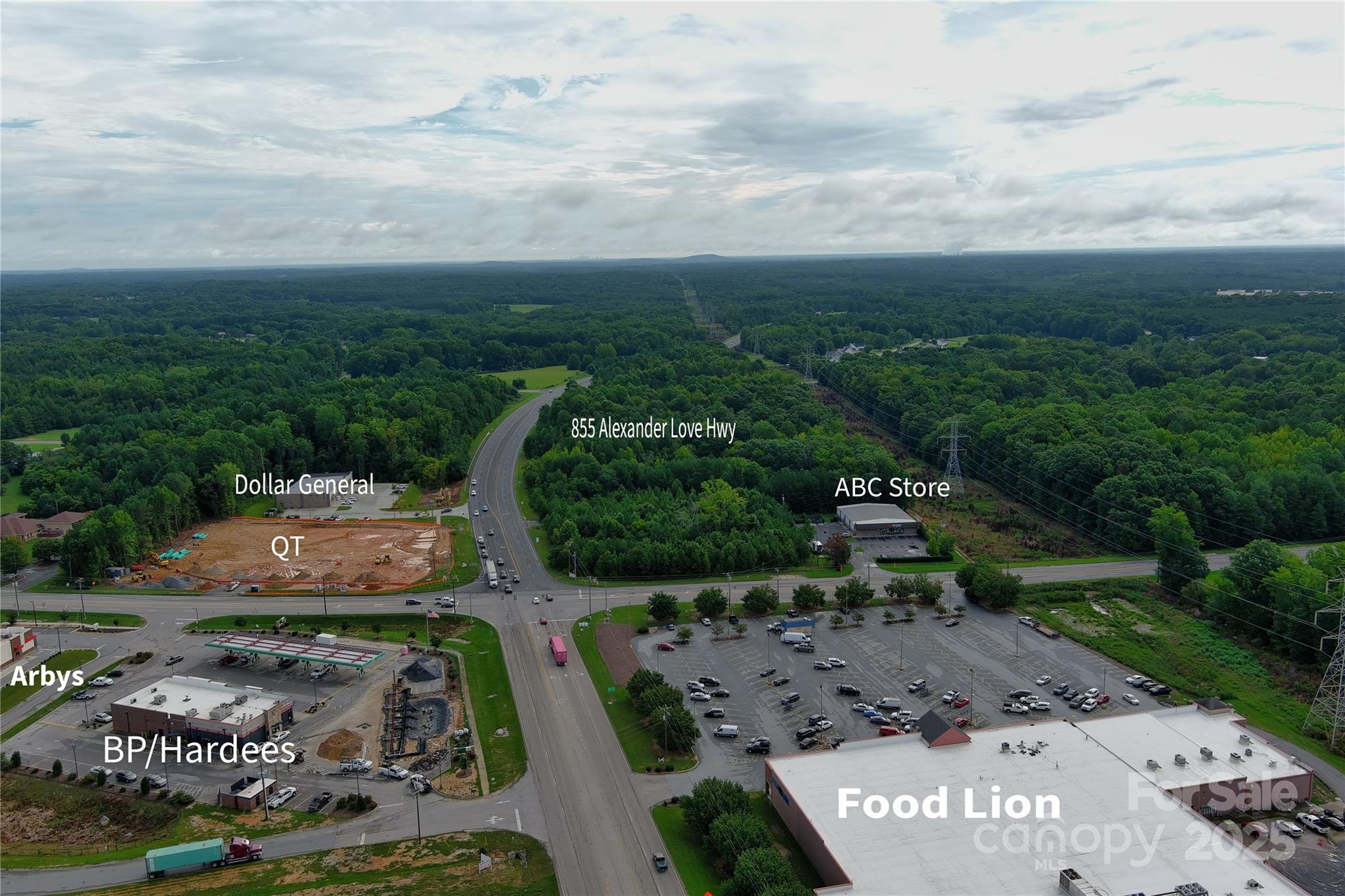 Prime Development Opportunity at 855 Alexander Love Highway in York, SC which is one parcel over from the corner of highway 321 and highway 5. This exceptional 10.54+/- acre tract is located in one of York County’s fastest-growing commercial corridors and offers outstanding potential for multifamily development, commercial and industrial. Positioned directly along Alexander Love Highway with excellent visibility and accessibility, the property sits in a rapidly expanding area surrounded by significant new residential and commercial growth. Water and sewer readily available. 

A major highlight of this opportunity is that the City of York has indicated multifamily rezoning may be a viable option for the property, creating substantial upside for developers seeking residential density in a high-growth area. With strong housing demand and thousands of approved residential units already in the pipeline nearby, this site presents a compelling opportunity for apartments, townhomes, or a mixed-use development concept. Any multifamily or residential development would be subject to a formal rezoning and approval process by the city.

The property is currently zoned Highway Commercial (HC) and General Industrial (GI), allowing flexibility for a broad range of uses including retail, restaurants, service-oriented businesses, logistics operations, warehousing, contractor facilities, automotive-related businesses, and travel-focused enterprises. Developers also have the potential to create a mixed-use environment with commercial frontage and residential uses toward the rear of the property.

One of the strongest attributes of this tract is its strategic location within an emerging commercial hub. A brand-new QuikTrip (QT) sits directly across the street, dramatically increasing traffic counts and consumer activity in the immediate area. Bojangles is also coming soon nearby, further reinforcing the corridor’s momentum and attractiveness for future investment. Additionally, property directly across the street has already been approved for 66 townhomes and two commercial outparcels, adding future rooftops and built-in consumer demand to the market.

York continues to experience substantial growth. The city has approved approximately 2,950 residential units, with only about 30% completed, leaving roughly 2,000 additional units still to be developed. This expanding population base is expected to continue driving demand for housing, retail, restaurants, services, and employment centers throughout the area.

The tract offers excellent topography that should accommodate a variety of site plans and development concepts. Water and sewer are available, further enhancing the property's development potential and helping streamline future development plans.

Whether you envision a multifamily community, mixed-use project, retail center, industrial development, or long-term investment hold, 855 Alexander Love Highway presents a rare opportunity to secure a sizable tract in the direct path of growth.

All information to be verified by buyer during due diligence.