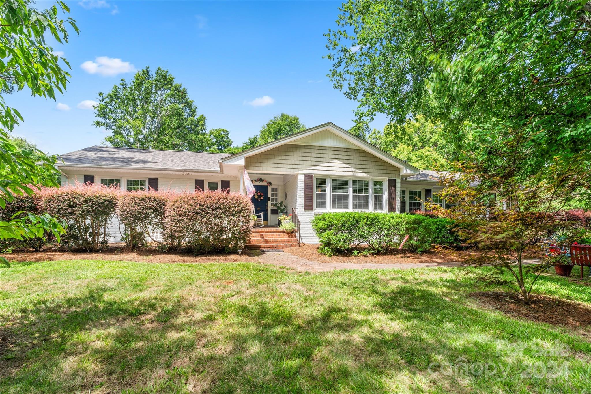 Lovely one level traditional in prestigious Fewell Estates. Property includes 520 sqft brick garage / utility building with power, water and sewer available to building.  Includes Formal Living room, dining room, separate den, plus large sunroom, detached garage and many hardwood trees in .6 acre lot. Fewell Estates has a neighborhood park with playground and tennis courts.  Home improvements include Levolor shades on porch, totally remodeled kitchen and primary bathroom in 2012.  Upgraded heating and air to 4 ton unit, new duct system. Refinished hardwood floors, tankless Rinnai water heater.  Roof recently replaced on house and garage, new exterior paint, new moisture barrier in crawlspace.  Beautiful oversized antique mirror above fireplace remains with home.  This home features a 230 sqft glassed in sun porch heated and cooled from adjacent family room.