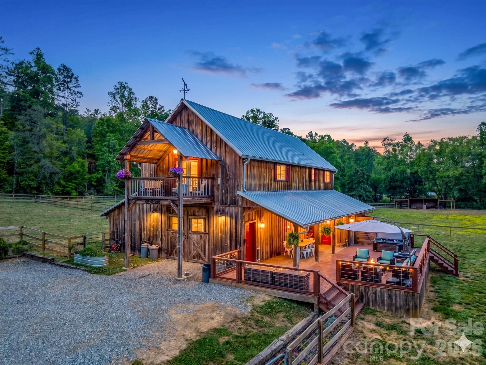 Recently reduced and now offered furnished, this unique property presents an incredible opportunity to start enjoying the mountain lifestyle from day one! Set on 35 picturesque acres, this dream farm showcases an authentic barndominium designed for both refined country living and full-scale functionality. The property offers a rare blend of comfort, privacy, and working farm infrastructure—perfect for equestrian enthusiasts, hobby farmers, or those seeking a self-sustaining lifestyle.

Inside, the home features a spacious open layout anchored by a massive kitchen island, ideal for gathering and entertaining with a stunning stone gas fireplace. Step out onto the covered balcony and take in sweeping views of the property below.  Enjoy a scenic pond with a fountain and waterfall, along with beautiful Cove Creek frontage for a peaceful waterfront setting. Your own private escape in the mountains. Every detail has been thoughtfully elevated throughout the home with two beautifully renovated bathrooms.

Outside, the large back porch is where this home truly shines. Featuring a hot tub, outdoor shower, and a recently renovated half bath. It’s the perfect space to unwind, entertain, or create the ultimate outdoor kitchen overlooking your land with a rustic woodfire smokehouse already in place!

This property is fully equipped for farm life with seven fenced pastures for rotational grazing with run in shelters, chicken coop, hog pen, and a two-stall horse barn with tack room, laundry, storage and a workshop. Additional outbuilding can be used as a second barn, hay, or garden storage.

At the highest point of this property, a private homesite positioned to capture long-range mountain views in every direction adds even more potential. An ideal setting for a future residence or legacy build.

This isn't just a farm. It is a lifestyle most people only dream about.

All showings must be listing agent accompanied. Please no drive-bys.