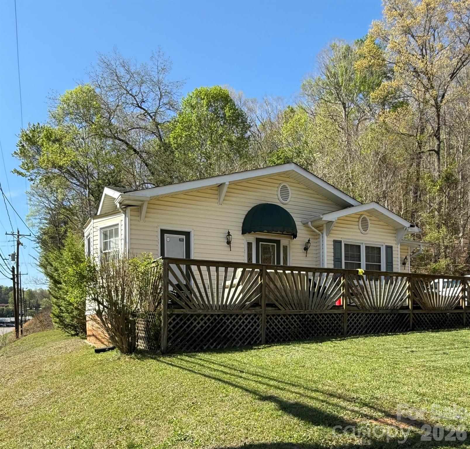 Over 11 acres conveniently located in the City limits of Marion! A house with this much acreage in town is simply not easy to find and, yet, here it is...located on N. Main St or what locals refer to as "the 5-lane;" the main corridor through the City of Marion. Currently, in use by a local non-profit, this location was previously a Chiropractor's office.

The property contains four (4) separate parcels with over 770' of road frontage; one (1) large land parcel, two (2) small land parcels (0.09 of an acre each), and the house is on 0.53 of an acre. The house has two bedrooms and a bonus room (currently used as a bedroom) which has its own outside access onto the porch/deck. Ceiling fixtures such as large medallions and a gorgeous chandelier with high ceilings and large crown molding give the spaces a dramatic yet classic feel. The exposed brick with an electric fireplace in the entry welcome all who come with a cozy atmosphere as do the hardwood floors through-out the main portion of the house. Small yet sufficient, the kitchen also offers access from the outside. The refrigerator and stove convey as do the washer and dryer in the spacious laundry room.

While the home offers adequate space there is also room for big dreams of a possible 2nd home atop the larger tract which, with some clearing, could boast of scenic views of the northern mountains. If another homesite is not what your heart desires, then consider a short-term rental with a private trail system running through-out the property to appeal to the growing hiking/biking community of visitors to the County or simply keep it as your backyard playground; future expansion of the Fonta Flora State Trail is proposed to occur along this roadway. A small complex of townhomes or apartments could also be positioned on the higher elevations of the property to provide many with a view to call home.


No matter the path the future owner decides to take, the road that leads there already exists, but will require additional work to sustain any traffic outside of personal use. The old roadbed to access the acreage is not located on the subject property, however, there is an existing 12' right-of-way along the road, is in good condition, and currently used by ATV to maintain the property. A small branch/creek running along the roadbed (also on the adjacent property) offers visual interest as well as a small waterfall and rock formations, before ultimately crossing onto the parcel containing the house.