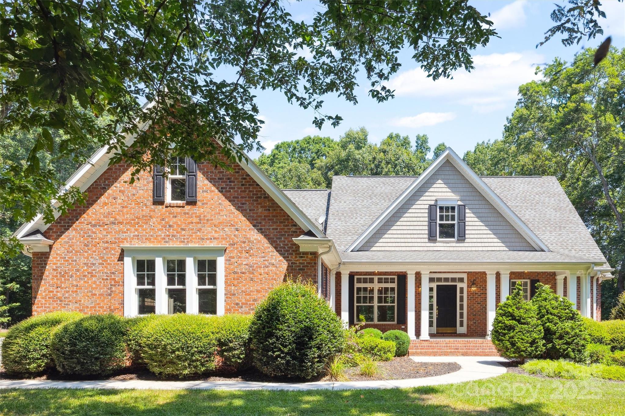 Tucked away on a quiet cul-de-sac in a charming 12-home brick community, this 1 owner, full-brick beauty on 2.6 acres offers space, privacy & standout features  + no HOA! Hardwoods in kitchen, living, dining & primary suite and whole house audio too. Main-level primary suite features a fireplace and luxury bath w/ dual vanities, walk-in shower, soaking tub, large walk-in closet PLUS a secure vault room–a must see! Stunning coffered ceiling kitchen w/ white cabinetry, large island & double ovens has great flow for entertaining into the living room with a 2nd fireplace. Enjoy the outdoors in the extra-large screened porch. Secondary bedrooms w/ a Jack & Jill bath have fresh carpet (2024). Large bonus room + 580 SF walk-in attic that can be finished for add. bed/bath! Epoxy floors in attached oversized 2 car garage. But wait…you’ll also have a detached garage + workshop including a dust collection system & flex space above. Eligible for 100% USDA financing. Discover this rare find today!