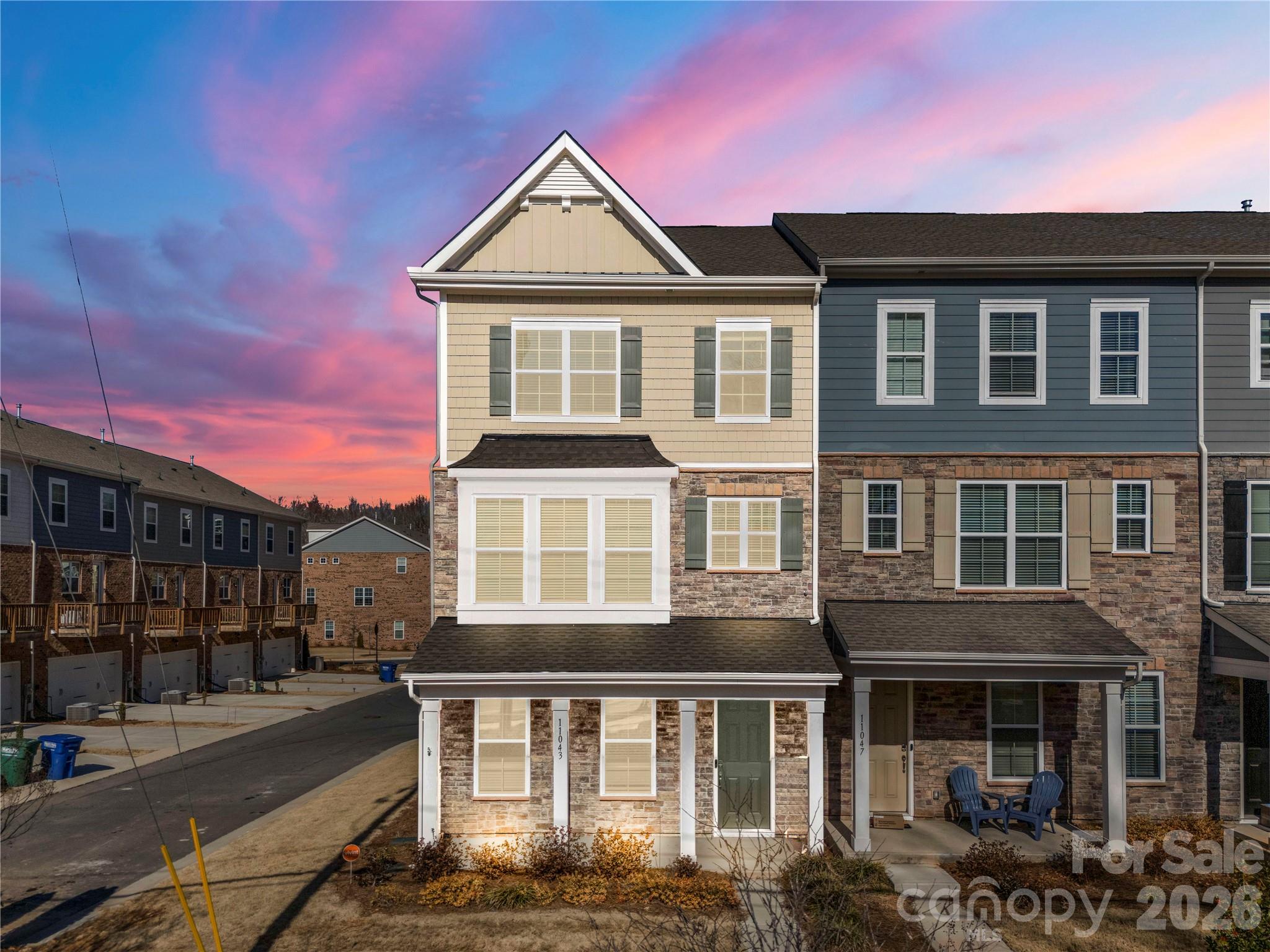Welcome to 11043 Lawyers Rd – a beautifully designed 3-level, 4-bedroom, 3.5 bathroom END-UNIT townhome with a 2-car garage and an open floor plan with abundant natural light! A first-floor bedroom with a full bath offers flexibility for guests or a home office.

The spacious main level features a gourmet kitchen, stainless steel appliances, and a large island—perfect for entertaining. Enjoy your morning coffee or unwind in the evening on your private balcony. Also featured is the dining area which flows seamlessly into the living room with an electric fireplace.

Located on the third level is the luxurious primary suite; a true retreat with tray ceilings and nice walk-in closet. Two other nice sized bedrooms complete the third level.

Conveniently located near shopping, dining, and major highways. Don't miss this incredible opportunity to own a gorgeous townhouse right in the heart of Charlotte!—schedule your tour today!