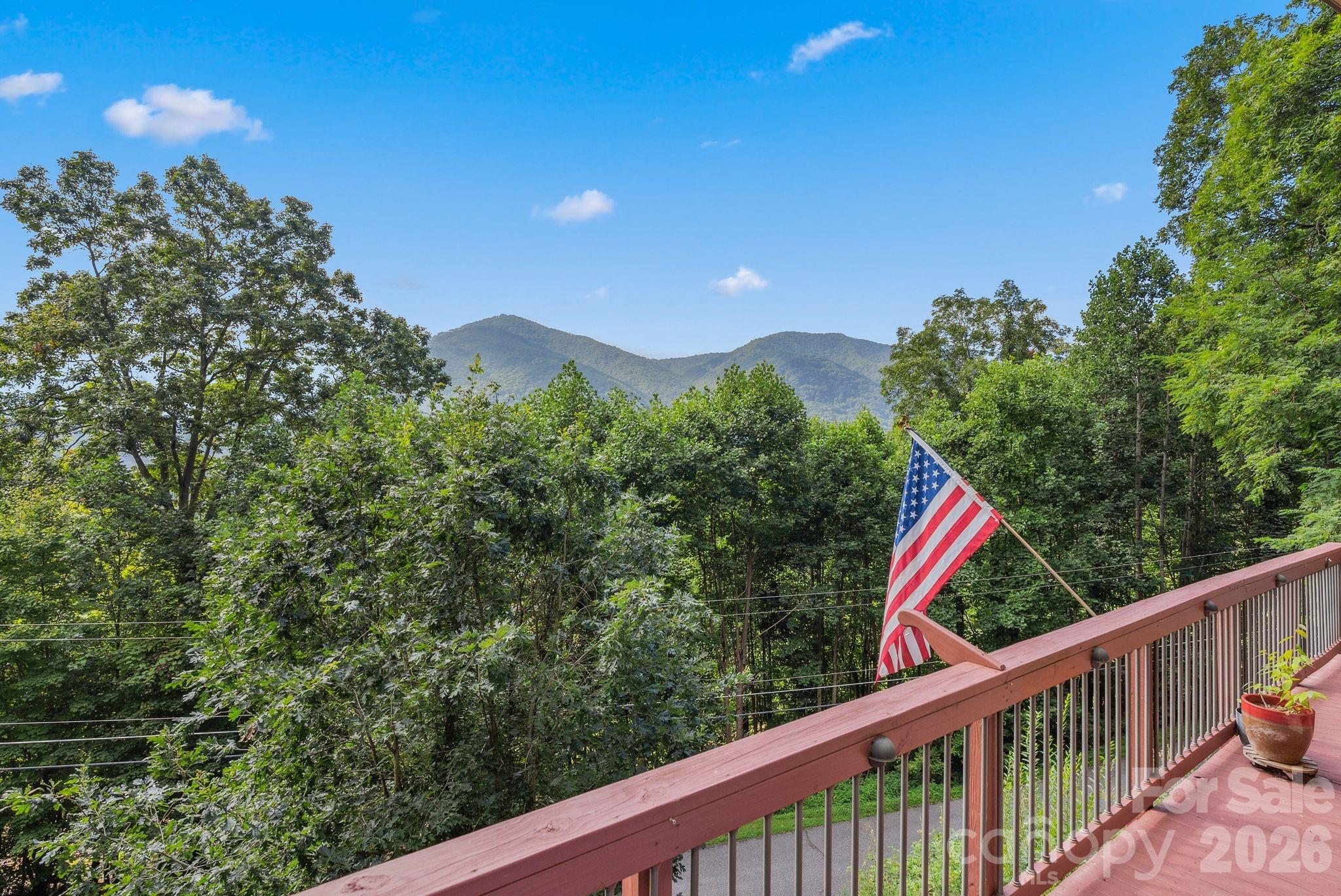 Investor Alert! This beautiful home is situated in the heart of Maggie Valley, offering stunning views and an abundance of natural light through its South facing windows. You can enjoy the day on the spacious deck while taking in those views or unwind in the soothing hot tub. The interior seamlessly blends modern elements with a cozy mountain ambiance. It meets functional needs with a primary bedroom and bonus room (previously used as a 4th room) conveniently located on the main floor, alongside ample parking options both covered and uncovered, and easy paved access with a recent reinforced retaining wall. Not only does this fully furnished home have a second living quarters in the lower portion but also conveys with a second lot located above the house off of Hidden Falls Road ensuring a sense of privacy with few neighbors or possible building site in the future. With a little bit of TLC this home can be ready for anything!