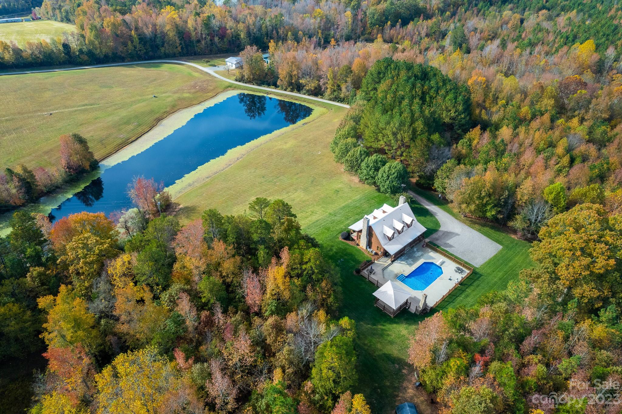 This charming log cabin, situated in Lexington, North Carolina, boasts over 2000 square feet of living space and offers a serene countryside retreat. Nestled on a sprawling 35-acre property, this home is surrounded by the beauty of nature. As you approach, a picturesque pond graces the front yard, adding to the calm landscape. The property also features a delightful saltwater in-ground pool accompanied by a gazebo and outdoor fireplace, creating the perfect setting for outdoor entertainment and relaxation. Powered 30X40 Morton building with 12 foot lean-to on back.