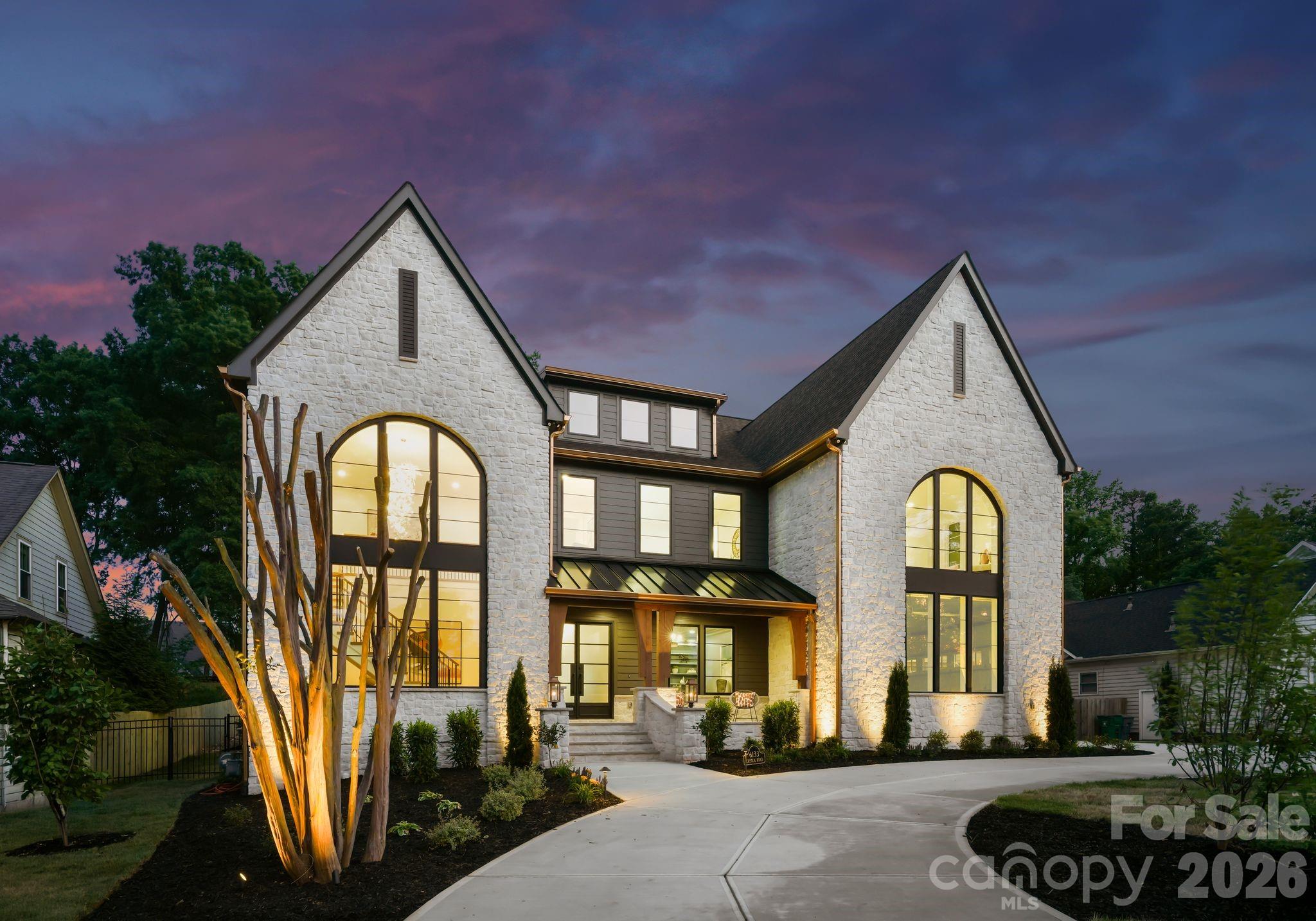 Refined Living. Effortless Entertaining. Welcome to an exceptional new construction home by KAD Homes—where elevated design meets the comfort of everyday living. From the moment you arrive, the striking stone exterior, arched windows, and circular drive set a tone of timeless elegance. Inside, every detail has been thoughtfully curated for both entertaining and daily life. The chef’s kitchen features custom cabinetry, Wolf and Sub-Zero appliances, quartz surfaces, and refined finishes, while a separate scullery keeps preparation tucked away—allowing the main space to remain polished and inviting. The dining area offers a custom beverage station with wine storage and flows seamlessly into the great room, where a dramatic stone fireplace and built-ins create a warm, welcoming gathering space. Expansive windows and glass doors fill the home with natural light and connect beautifully to the outdoor living areas. The main-level primary suite is a private retreat with elegant architectural detail and a spa-inspired bath featuring custom cabinetry, designer finishes, and a soaking tub designed for relaxation. A well-appointed office provides a quiet and sophisticated workspace. Upstairs, thoughtfully designed bedrooms, flexible living spaces, and beautifully finished baths offer comfort and versatility for family and guests. A spacious bonus room—prewired for surround sound and a projector—creates the perfect setting for a private media experience. The outdoor living is equally impressive, designed for both entertaining and unwinding. A saltwater pool with an extended tanning ledge, oversized spa, and fully equipped outdoor kitchen set the stage, while a putting green adds a unique touch. The poolside cabana, complete with Summer Kitchen with outdoor refrigerator, ice maker and full bath, allows guests to relax comfortably without ever stepping inside. Custom cabinetry, curated finishes, and intentional design details throughout complete this remarkable home. A rare opportunity to enjoy elegant living, designed for gathering and meant to be lived in.