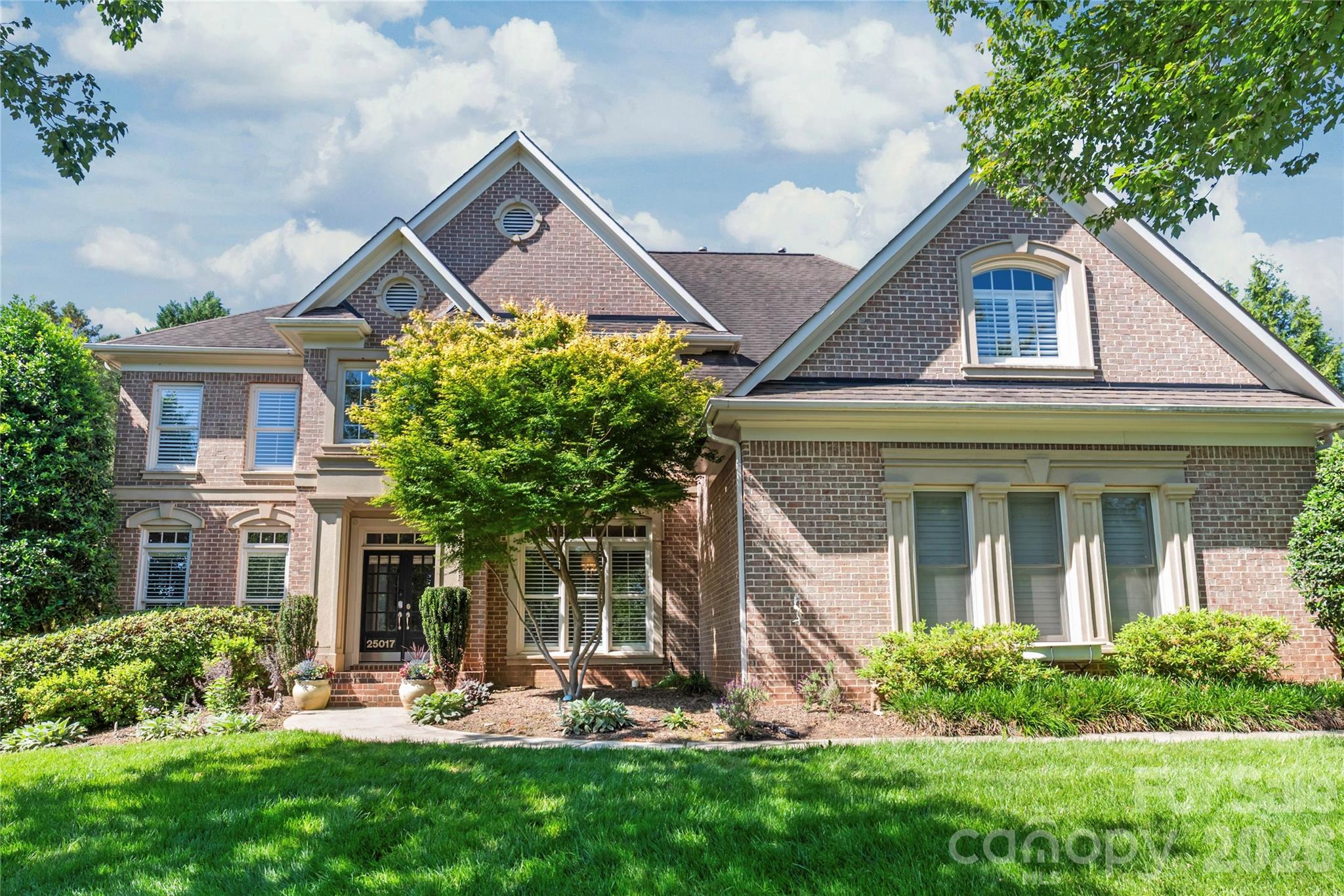 Welcome to a life of unparalleled luxury, comfort, and community in Bridgehampton. From the moment you arrive, this striking, three-sided brick John Wieland "Columbia" plan captivates with its three-car side-load garage and beautiful curb appeal. Step through the grand foyer, where elegant hardwood floors guide you into a bright, open floor plan designed for seamless everyday living. At the heart of the home is a fully renovated chef’s kitchen—a culinary masterpiece featuring custom shaker cabinetry, abundant storage, and a generous central island with a built-in wine fridge where guests will naturally gather. Just beyond, the dramatic two-story great room takes your breath away with its soaring architectural details and expansive picture windows that flood the space with natural light.

The main level offers a rare and incredibly valuable asset: a full in-law suite or teenage hangout suite complete with its own dedicated bedroom, kitchen, living and dining area, and a thoughtful zero-entry shower equipped with grab bars. Upstairs, the luxury continues with four spacious bedrooms, each enjoying direct access to an en suite or Jack-and-Jill bath. The expansive primary suite is a magnificent sanctuary featuring a show-stopping, custom-designed boutique closet (newly completed in 2026) with a center island and glass display cabinets, plus two additional walk-in closets for effortless organization. The third floor delivers ultimate flexibility with a massive recreation room perfect for a home theater or playroom. Peace of mind is built right in, highlighted by updated designer lighting throughout, plush new second-floor carpeting (2025), and completely upgraded plumbing (2025) installed during the suite addition.

Step outside into your private backyard oasis, a meticulously designed outdoor retreat backing up to a lush canopy of mature trees. Perfect for morning coffee or winding down with a glass of wine, this fully fenced entertainer’s dream features a cozy lounge area with an outdoor wood/gas stone fireplace and TV hookup, flanked by a beautiful gazebo. The premium outdoor kitchen is fully equipped with a grill, outdoor sink, and bar area for effortless hosting. Say goodbye to muddy paws and high lawn maintenance—the pristine artificial turf provides the perfect year-round surface for soccer matches, lawn games, or a round of frisbee golf.

Beyond the property line lies a vibrant, active lifestyle where neighbors truly connect. You are just a short walk away from Bridgehampton’s resort-style amenities, including a spectacular pool with a giant spiral water slide, a splash pad, tennis and pickleball courts, a clubhouse with a fitness center, a playground, basketball courts, and scenic walking trails. Best of all, you are situated just 2.4 miles from the premier dining, shopping, and entertainment at the Ballantyne Bowl. This property offers the best of both worlds: a highly coveted Ballantyne lifestyle paired with the advantage of low South Carolina taxes.