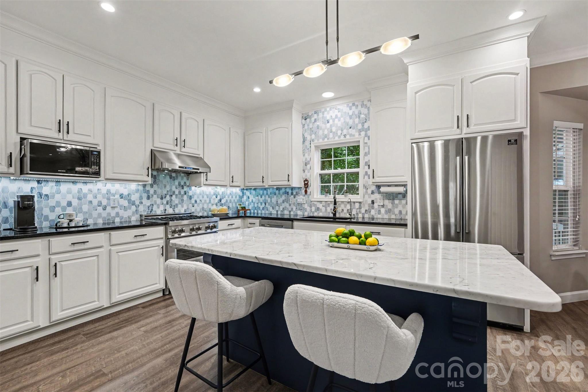 Welcome to this beautifully upgraded home that blends modern elegance with everyday comfort. The heart of the home is the stunning kitchen, featuring a premium ZLINE gas range, stainless steel appliances, granite and marble countertops, a spacious center island, designer backsplash, and high-end ceiling-height white cabinetry—perfect for both entertaining and daily living. The open-concept layout seamlessly connects the kitchen to the family room, where you’ll find a cozy gas fireplace highlighted by an upgraded mantle, creating a warm and inviting focal point. A separate dining room and formal living room or office with French doors offer flexibility for any lifestyle.  The first floor showcases durable and stylish luxury vinyl plank flooring throughout, complemented by upgraded light fixtures that elevate every space. Retreat to the luxurious primary suite up, complete with a spa-inspired bath featuring a freestanding soaking tub, ceramic tile flooring, double vanity, and a seamless glass shower with a rain shower head. The primary suite also includes a walk-in closet with custom built-in cabinetry. A secondary full bath upstairs offers an upgraded vanity with modern hardware for added style and function.  Generously sized secondary bedrooms and even some attic storage space.

Step outside to your own private oasis—a beautifully manicured, fully fenced backyard with mature trees, fruit trees, and elevated garden beds. Enjoy year-round relaxation on the oversized screened-in porch equipped with ceiling fans, perfect for entertaining or unwinding.  Sprinkler system, front, back & sides provides effortless lawn hydration.

Additional highlights include a newer roof (approximately 2 years old), HVAC system replaced in 2021 and a reverse osmosis filtration system for added peace of mind.

This exceptional home truly has it all—style, comfort, and thoughtful upgrades throughout. Clubhouse, neighborhood pool, walking trails, sidewalks, streetlights and playground.  Lower Union County Taxes, great Cuthbertson schools and close to shopping and restaurants make this the perfect home in the highly desirable Stonegate Neighborhood.  Seller is including a Home Warranty!