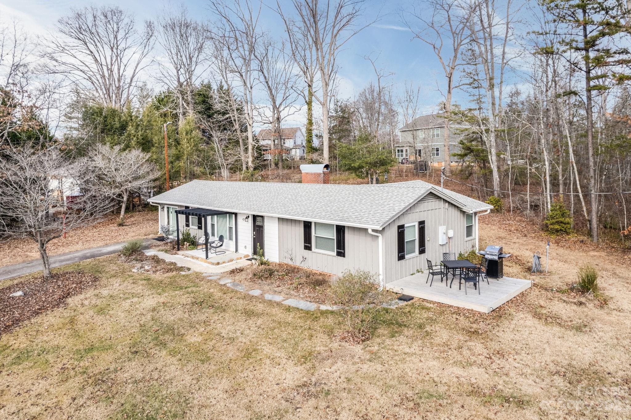 Charming one story home with 2 BR/1 BA on level .77 acres. The living room boasts natural light , a  beautiful wood burning fireplace, and long range mountain views. The modern kitchen has stainless steel appliances, butcher block countertops, and  a breakfast nook. The cozy bedrooms and  spacious bathroom both have shiplap for the modern farmhouse look. The family room/office could be used as a flex space. The laundry room/mud room is just off the family room. Large level yard with 10/10 deck and pergola, and a great yard  for gardening. Conveniently located just 8 minutes from Black Mountain and 22 minutes from Asheville via I-40, this home offers easy access to both city amenities and the tranquility of mountain living. Just 2 miles away from downtown Old Fort, easy access to charming shops and breweries. All furnishings negotiable.