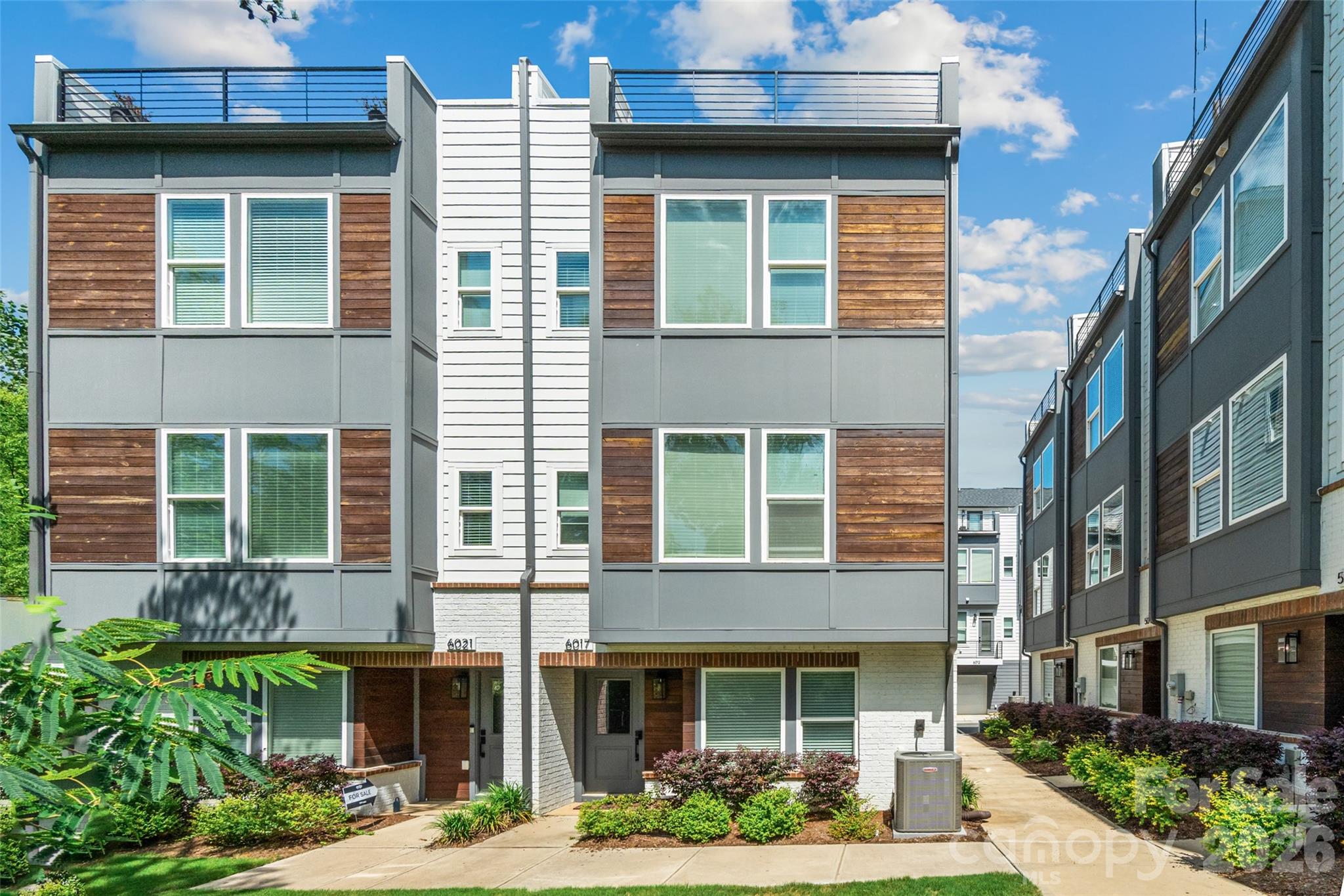Amazing opportunity to live in LOSO under 750k! **SELLER IS OFFERING A 2-1 BUY DOWN WITH ACCEPTABLE OFFER -- SAVES YOU THOUSANDS ON YOUR MORTGAGE PAYMENTS**  Freshly painted and ready for its new owners!! Perfectly positioned just steps from local breweries, popular restaurants, and the nearby LYNX Blue Line, this stunning four-level townhouse offers the ultimate urban lifestyle with space to live, work, and entertain.

The entry level features a spacious side-by-side two-car garage, along with a private bedroom and full bath, ideal for guests, a home office, or multigenerational living.

Upstairs, the main living level is truly the heart of the home, filled with natural light and designed for gathering. The oversized kitchen island anchors the space, complemented by an open living and dining area and a private terrace perfect for morning coffee or evening unwinding.

The third level offers a luxurious retreat with a large primary suite, complete with a spa-inspired bath and generous closet space. A second spacious bedroom with its own en suite bath provides comfort and privacy for family or guests.

The fourth level is incredibly versatile, featuring a full bath and flexible living area that can serve as a fourth bedroom, office, fitness studio, or creative space. This level opens to the show-stopping rooftop terrace, an incredible outdoor oasis overlooking a serene, tree-lined setting. Whether entertaining friends or enjoying a quiet sunset, this space delivers a rare blend of privacy and city living.

This is urban townhome living at its finest! Space, style, and a location that simply can't be beat.