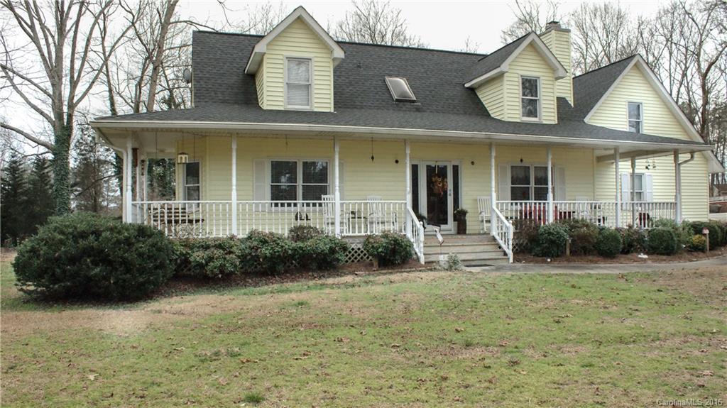Large Country style home w/ wrap around porch. Pre-engineered hardwood floors. Large master on main w/ double vanities. 2 extra large bedrooms and a bonus with lots of closet space.  Sun room & large covered deck.  2 parcels are being sold together. House parcel #38200083 is 1.27 ac.res. Lot parcel 3820000082 is 1.08 acres. 2 car garage plus 3 slot carport. Greenhouse and out buildings stay. Yard is fenced w/ sprinklers in beds. Property is in cul-de-sac directly across from Clover High School.