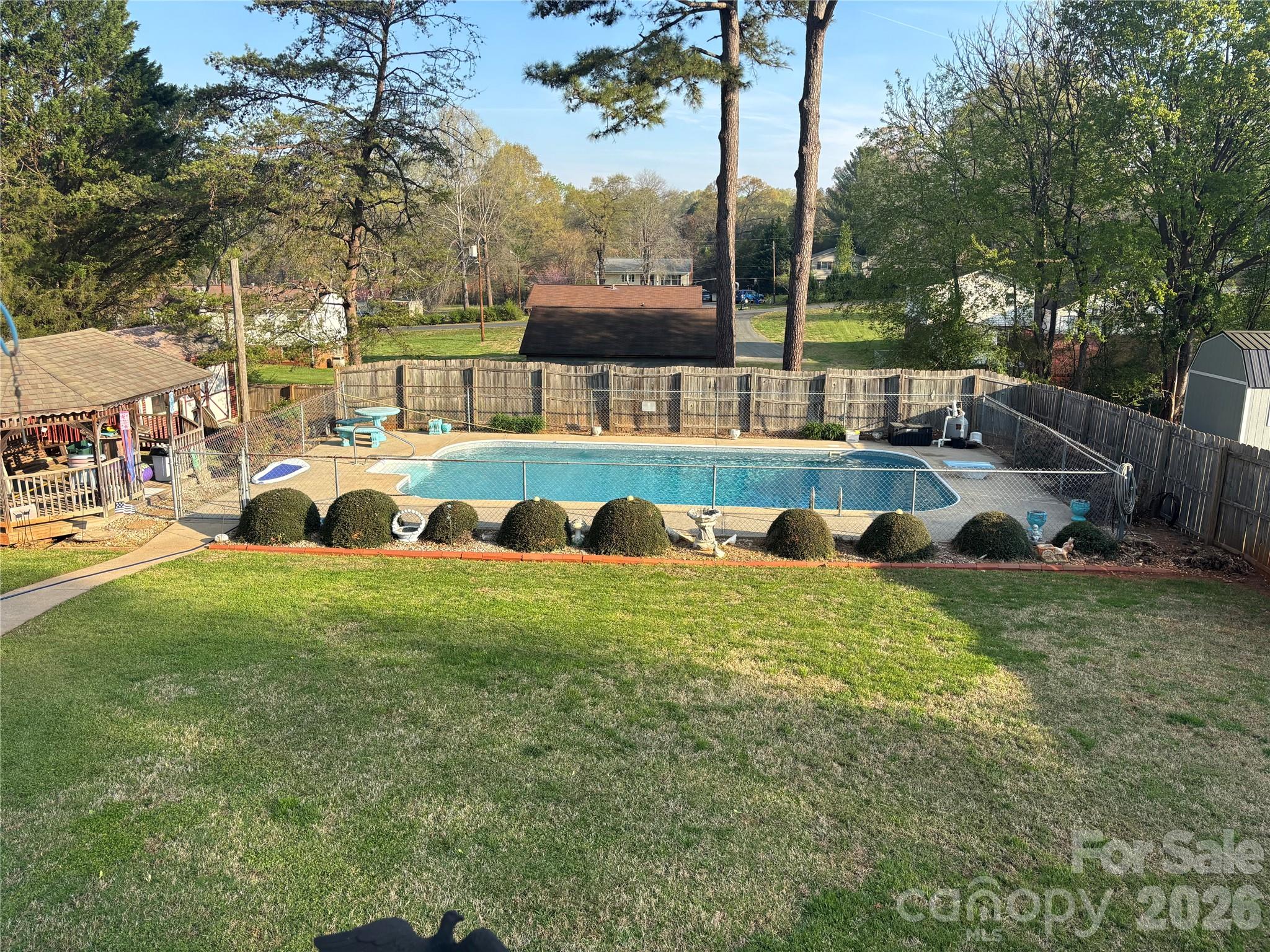 Charming One-Owner Split Level with Pool and Unique Backyard Oasis

Pride of ownership shows throughout this one-owner split-level home! Though the interior reflects its original era, it has been immaculately maintained and is ready for its next chapter. This 3-bedroom, 1-bath home offers a versatile layout and sits in an ideal location close to local conveniences and community amenities.

Step inside to find spacious living areas filled with natural light and endless potential for modern updates. The entry-level one-car garage can easily double as an enclosed outdoor space, perfect for entertaining or relaxing year-round.

Outside, discover a truly unique backyard designed for enjoyment and creativity — featuring a sparkling pool, a small bath house, and a separate storage building, all surrounded by mature landscaping that adds privacy and character.

The lower level includes a roll-up door for additional storage or workshop space, adding even more functionality to this well-loved home.

If you’re looking for a solid home with great bones, beautiful outdoor features, and room to make it your own, this is the one.