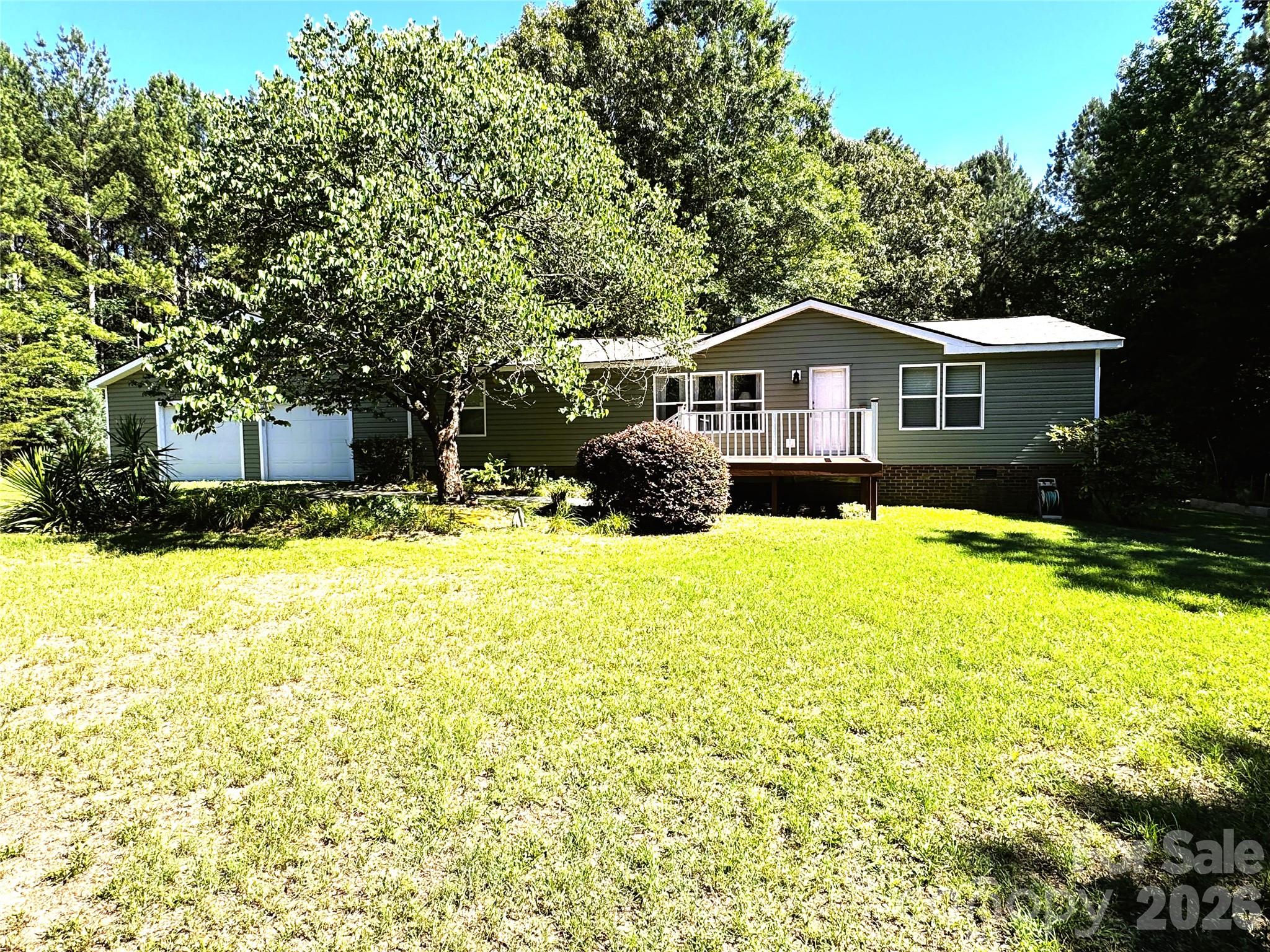 So many upgrades, privacy, and space! This beautifully remodeled home sits on 2 acres along a private road. New vinyl siding adds to the curb appeal and complements the many updates throughout the home. Enjoy your morning coffee in the new sunroom overlooking the peaceful, shaded backyard. Both bathrooms have been thoughtfully updated with porcelain tile floors and stylish marble/terra cotta wall finishes. The owner’s suite features a spacious walk-in shower. The updated kitchen offers a new electric stove, range hood, countertops, and backsplash. Seller leaving refrigerator, washer and dryer. Relax or entertain on the new patio overlooking the property. Need room for large vehicles or hobbies? The new 32x32 garage features finished walls, and epoxy floors, providing plenty of space and functionality including a separate breaker box.  A private retreat with modern updates throughout!