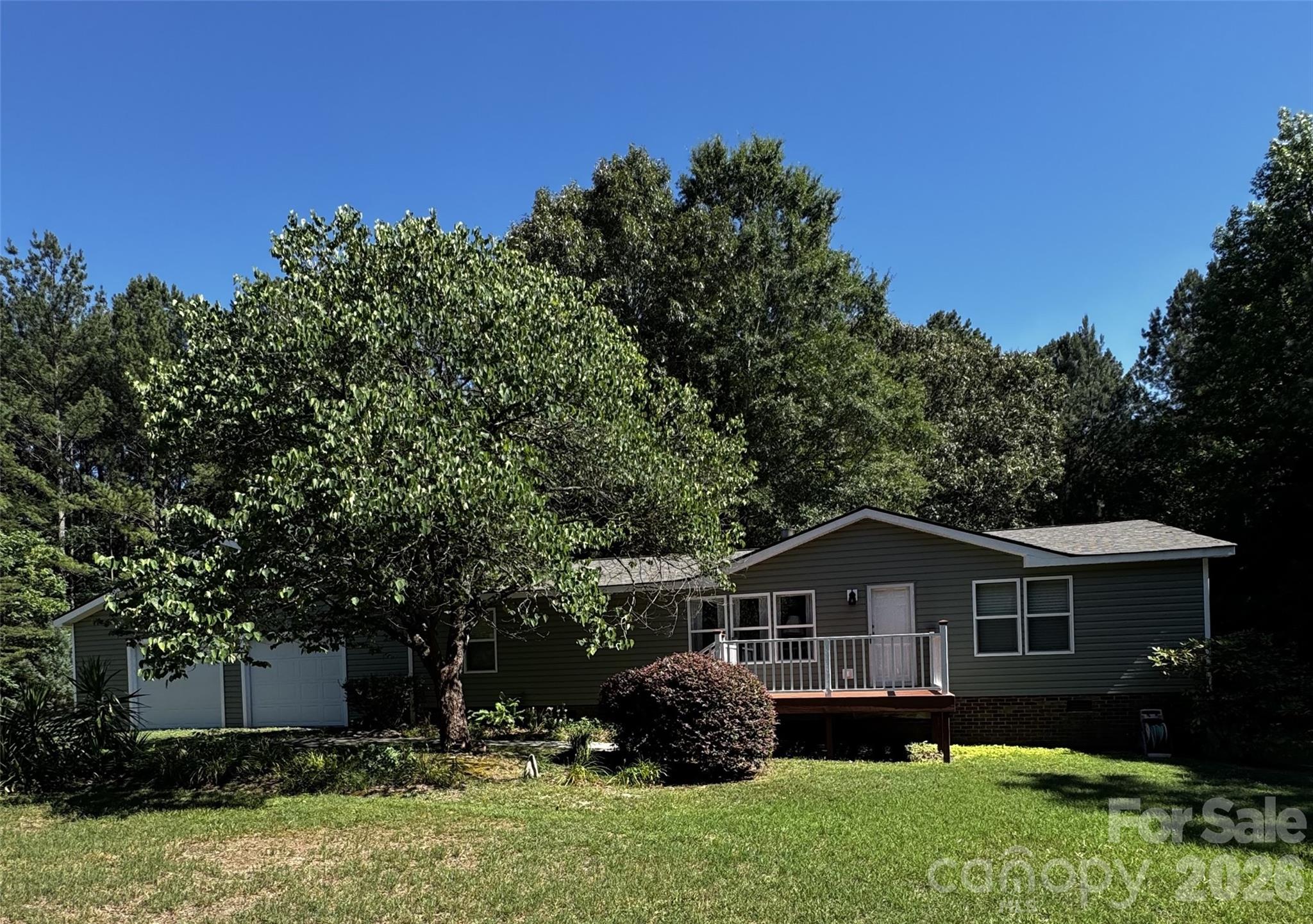 Motivated seller! This home has upgrades, privacy, and space! This beautifully remodeled home sits on 2 acres along a private road. New vinyl siding, soffits, and double-pane vinyl windows enhance the curb appeal and complement the many updates throughout the home. Enjoy your morning coffee in the new sunroom overlooking the peaceful, shaded backyard. Both bathrooms have been thoughtfully updated with porcelain tile floors and stylish marble/terra cotta wall finishes. The owner’s suite features a spacious walk-in shower. The updated kitchen offers a new electric stove, range hood, countertops, and backsplash. Seller leaving refrigerator, washer and dryer. Relax or entertain on the new patio overlooking the property. Need room for large vehicles or hobbies? The new 32x32 garage features finished walls, and epoxy floors, providing plenty of space and functionality including a separate breaker box.  A private retreat with modern updates throughout!