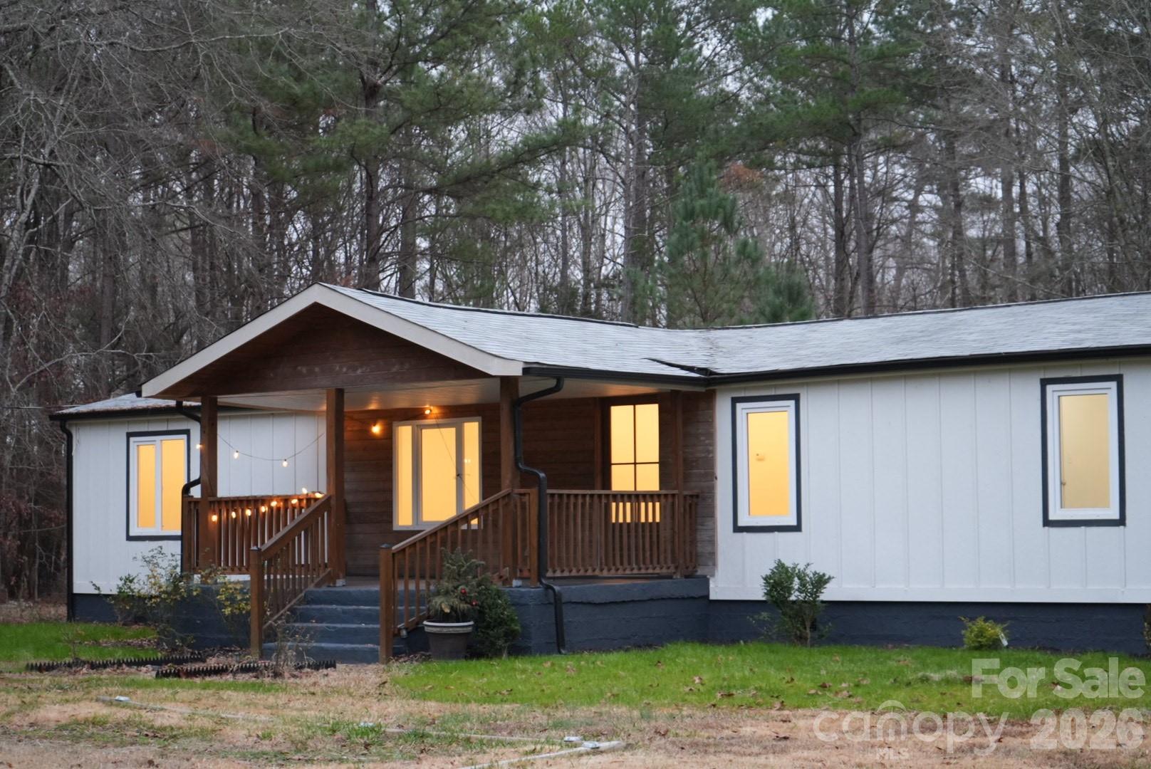This fully remodeled former double-wide sits on a spacious one and a half acre lot, ready to become your home. Located on a quiet street in the northeast part of Lancaster County, just a few miles from the North Carolina border, this property offers peace and convenience. Renovations include new European windows, insulation, drywall, kitchen, electrical, plumbing, HVAC system, rear porch, fresh paint, and updated bathroom fixtures. It's close to Lancaster, Waxhaw, Monroe, and Cane Creek Park. The sale includes three parcels, with the second and third being the buildable as well. The house is located on a half of the acre with the appr acre being on front and one and a half behind the residence.