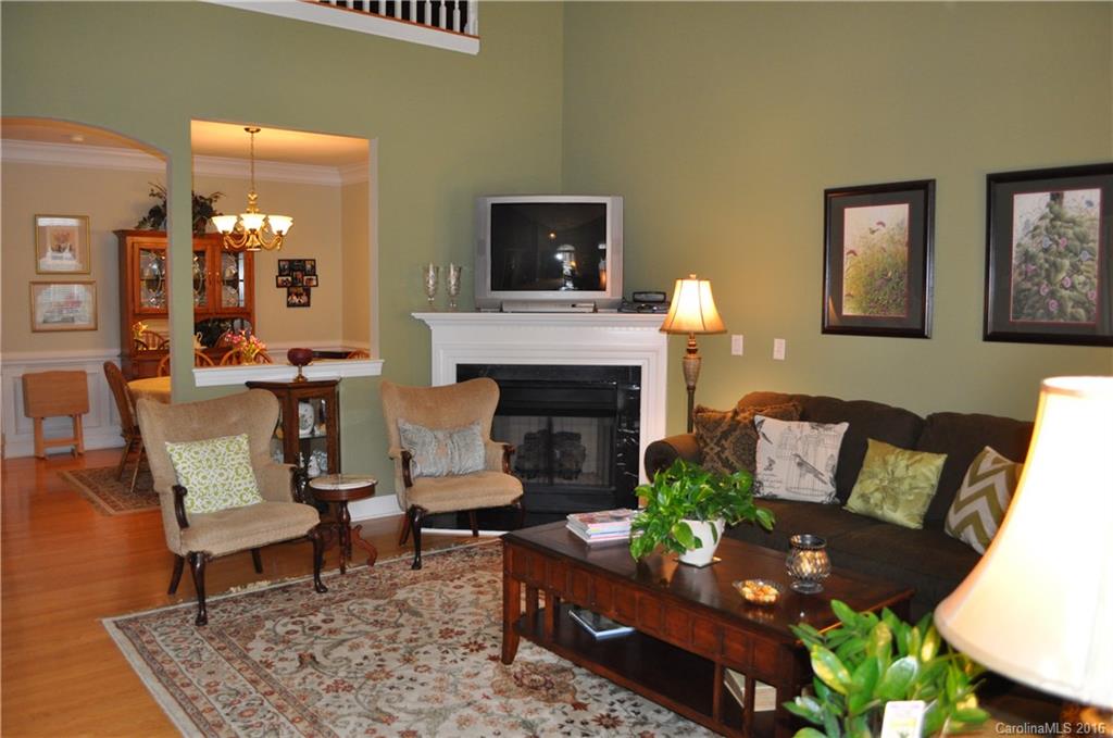 Main Floor All Brick Maintenance Free Living at its best!  2 minutes from I-77 and Dave Lyle Blvd, walking distance from the movies, restaurants, Target,  craft and book stores but in a perfectly quiet neighborhood.   Beautifully kept and recently painted with contemporary white kitchen, engineered wood floors through main level ex. kitchen, large main floor bedrooms, den on second floor near huge walk in attic storage.  Private brick-enclosed courtyard. 9 foot ceilings and open floor plan