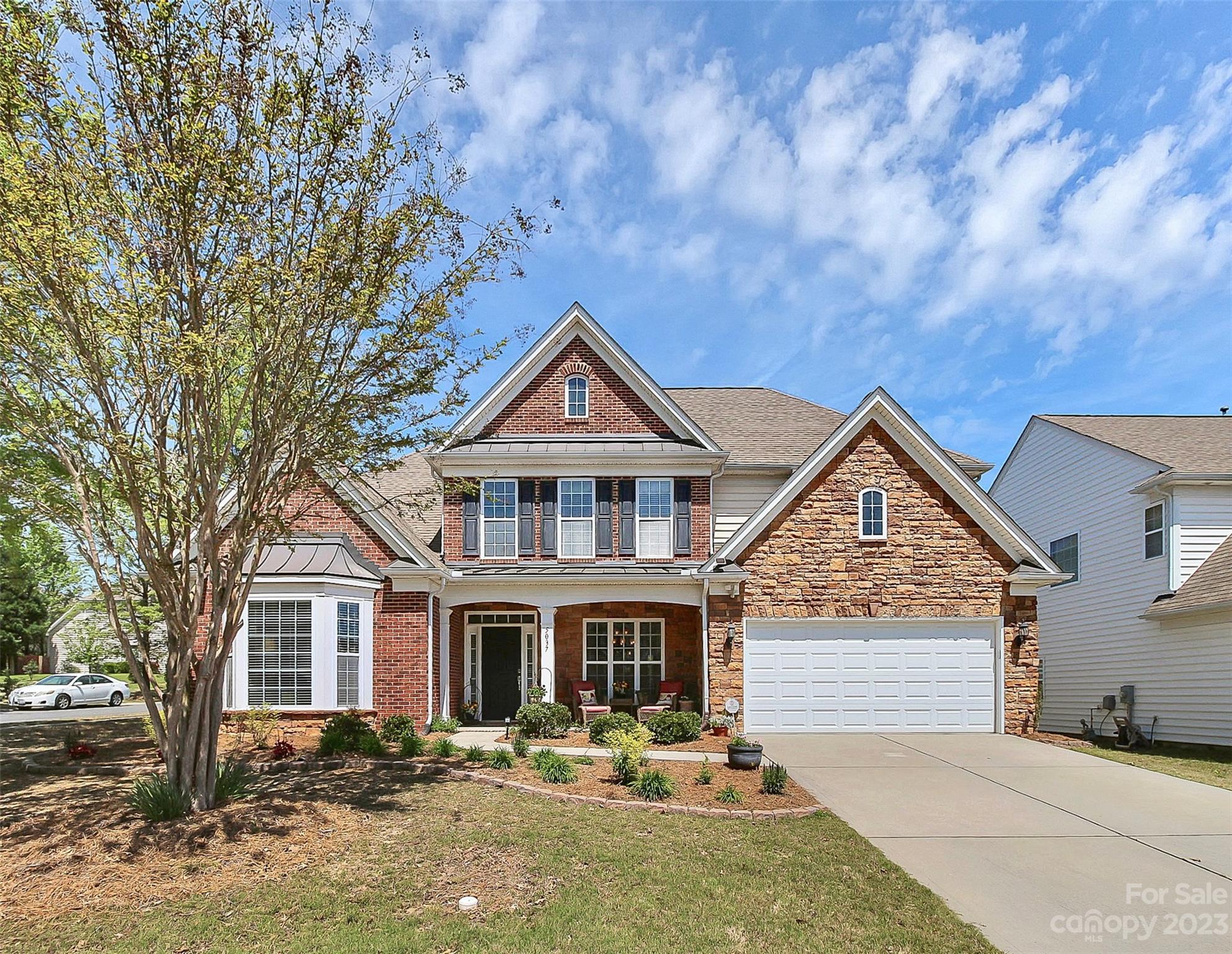 Welcome home to this beautifully maintained home in Belair at Carolina Lakes!  You will love the covered front porch with stone and brick accents! This popular floor plan features the primary bedroom suite and office/den/flex space on the main level.  Hardwood floors and extensive moldings throughout most of the main level.  Plenty of room to entertain in the two-story living area and spacious formal dining room joined with a butler's pantry.  Awesome storage in the kitchen with tons of cabinets, five burner gas cooktop, wall ovens, granite counter tops, island, desk, and large pantry.  Upstairs you will find three additional bedrooms (one with private bath and two others share a Jack and Jill bath), and a large bonus room.  Storage is not an issue with the two large walk-in attic storage areas.  Fabulous location within one mile of grocery stores, drug stores, restaurants, shopping center, and medical offices.