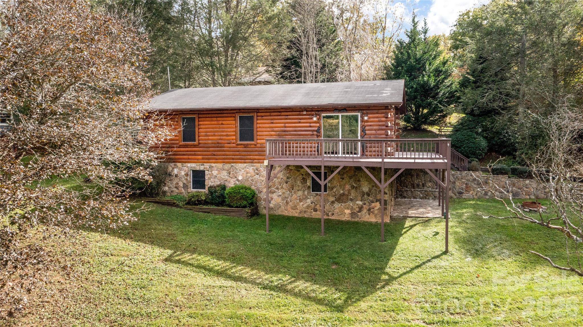 Escape to the peaceful Bethel community of Haywood County in this charming 2BR/1BA mountain home on nearly an acre of gently rolling land. Enjoy long-range mountain views, mature landscaping, a tranquil pond shaded by graceful curly willow trees, and a spacious deck perfect for morning coffee or sunsets. Inside, the home offers an easy-to-maintain single-level floor plan ideal for full-time living, a mountain retreat, or an investment opportunity. A detached 10' x 16' storage building provides extra space for tools, hobbies, or outdoor equipment. Additional features include a private well with a frost-protected well house, whole-house water filtration, and an EnergySmart water heater for added efficiency and reliability. Conveniently located just minutes from Waynesville, Canton, Lake Junaluska, Lake Logan, Harrah's Cherokee Casino, and the Blue Ridge Parkway, you'll enjoy the best of Western North Carolina's hiking, fishing, and mountain lifestyle. Buyer Incentive: Qualified buyers may receive a lender credit equal to 0.50% of the loan amount toward closing costs through Primis Mortgage, subject to credit approval and program guidelines.