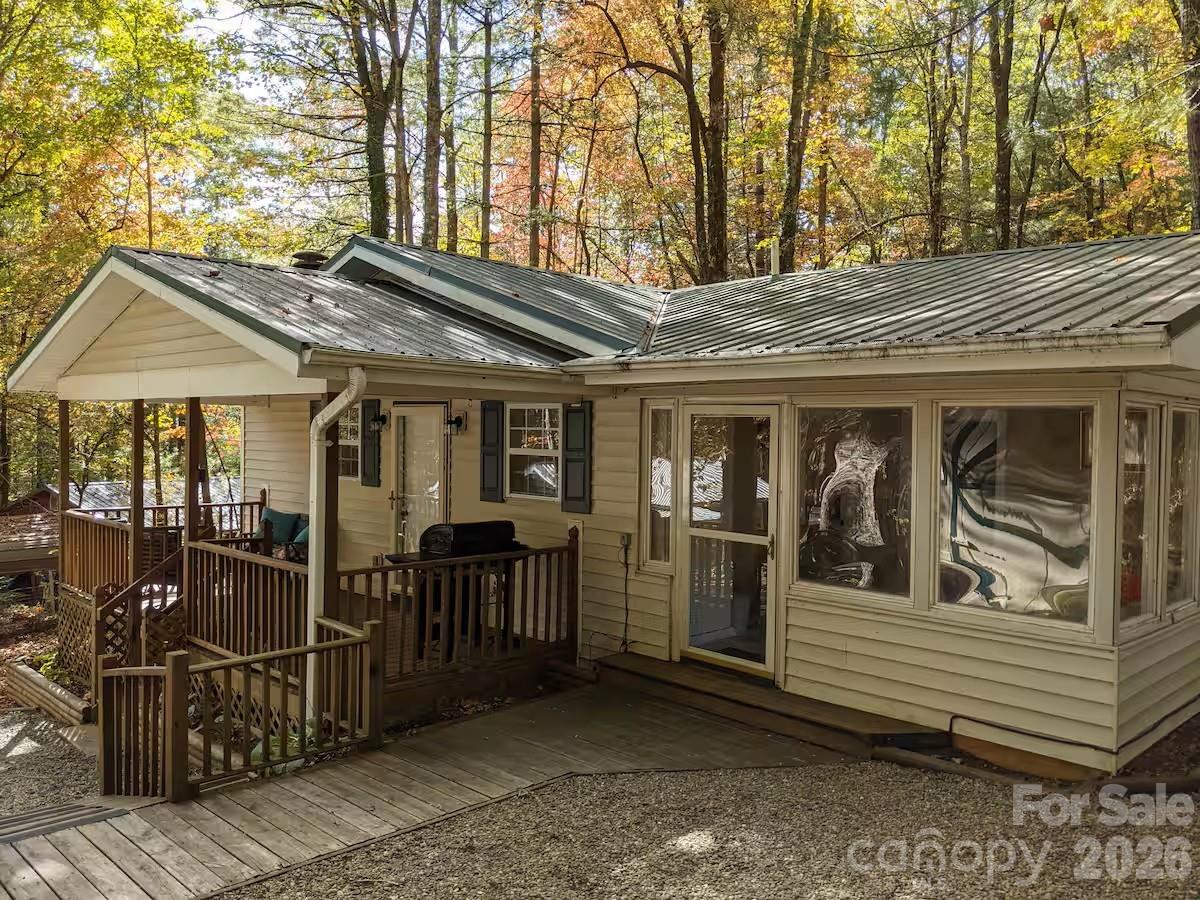 The Britt Cottage is a warm 2 bedroom, two bathroom home located in the Line Runner Ridge Community. It is in a quiet, forested area surrounded by few neighbors. The heating and cooling are through four high efficiency mini-splits which can be controlled remotely via app. There are two gas fireplaces that can heat the house independently even if the power fails. The water heater is a high efficiency “heat pump”. The master bedroom has ample closet space PLUS a w-a-l-k-in closet with additional closet, dresser and hanging space. The kitchen features a granite countertop. The house has wood and tile floors and a metal roof. The hot tub is a 2023 new with a roof overhead. A covered carport is located next to the house for parking as is a separate concrete parking slab separate from the driveway. There is a 12ft x 12ft shed for storage. The house is efficient in energy use and is a quiet refuge for the current owner located about 14.5 miles from Brevard and 5.6 miles from Rosman. It will be sold with all furnishings The community has a lake with a lakeside dock and picnic area within a short distance of the home. We have fiber internet exceeding 400MB!