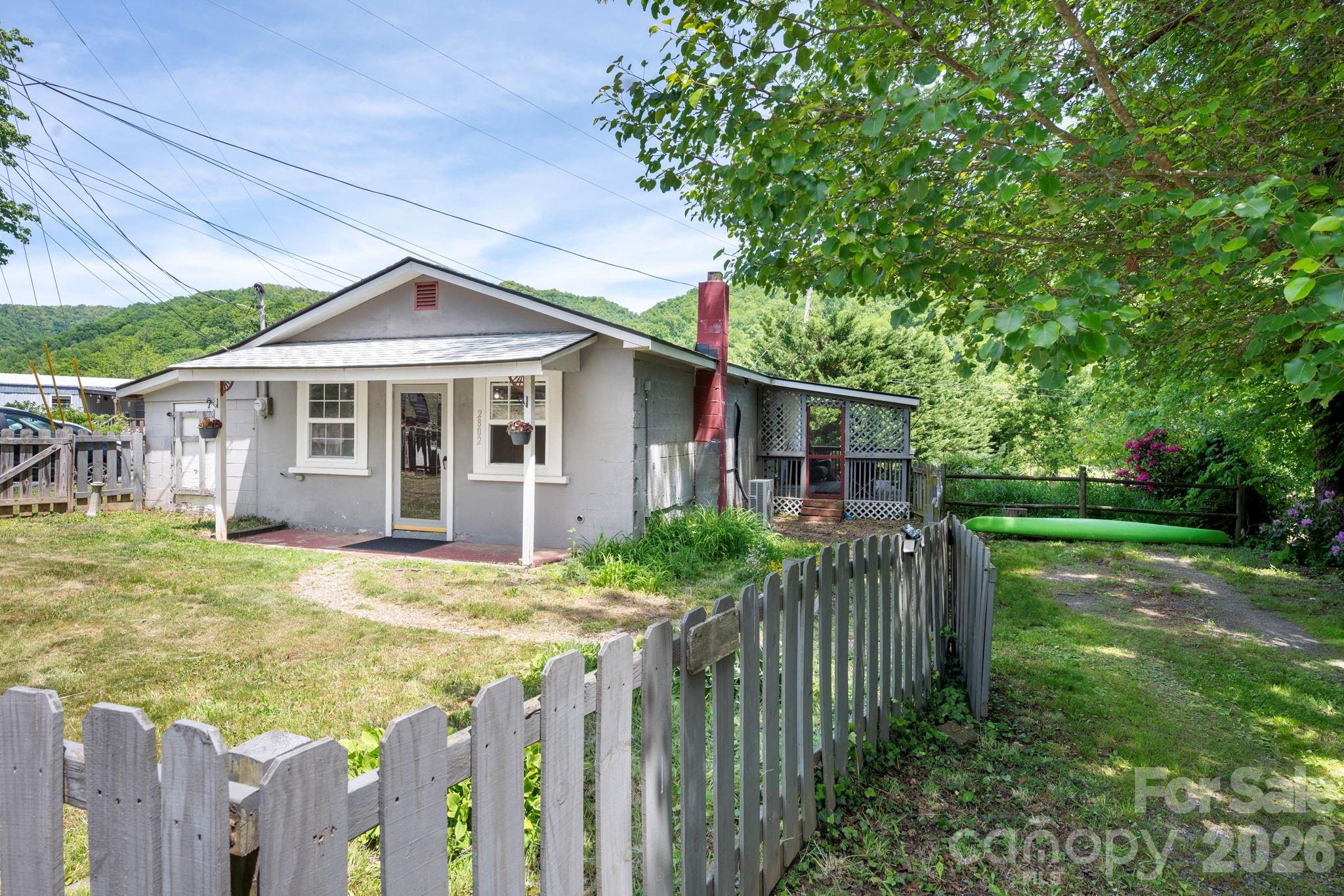 Welcome to this charming home located in the picturesque Beaverdam Valley of Canton. This 821-square-foot residence offers the perfect blend of comfort and modern efficiency on a manageable 0.22-acre lot.
Step inside to discover a bright, one-level open floor plan featuring a spacious bedroom, a full bathroom, and a versatile flex space ideal for a home office or guest area. The heart of the home features a cozy wood-burning stove and a modern kitchen equipped with stainless steel appliances, including an induction range oven and refrigerator.
Major updates provide peace of mind, including a new roof installed in 2022, a Mini Split HVAC added in 2020 for year-round comfort, and a new water heater installed in 2023. For added convenience, the washer and dryer convey with the property.
The outdoor living spaces are just as inviting, with a private covered side porch and a fenced front yard featuring a covered patio. There is ample off-street parking available. Outdoor enthusiasts will love the close proximity to the Rough Creek Watershed Trail System, while everyone will appreciate being less than 5 miles from Canton and nearby grocery stores. With Asheville and Waynesville both just a 20-minute drive away, this home offers peaceful valley living with easy access to city amenities.
Don’t miss MLS# 4382703!