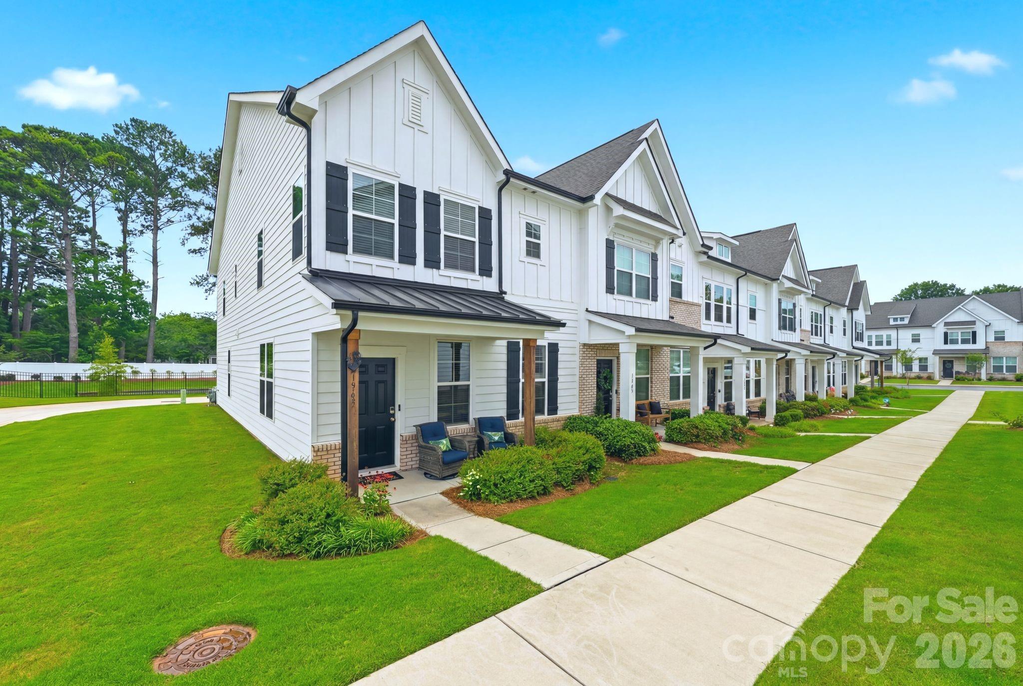 The best lot in the neighborhood! This private end-unit townhome backs to a large fenced green space, perfect for relaxing, exercising, playing, or letting your pet run freely. Better than new, this beautifully maintained home features brand-new luxury vinyl plank flooring throughout the entire upstairs and is completely move-in ready. Enjoy the freedom of low-maintenance, lock-and-leave living while the HOA takes care of the exterior maintenance. Ideally located in Rock Hill, you're just a few minutes from shopping, restaurants, and I-77 for quick access to Charlotte and Fort Mill. Designed for entertaining, the open floor plan showcases timeless craftsmanship and quality upgrades throughout. The spacious kitchen features granite countertops, a 5-burner gas cooktop, abundant cabinetry, a walk-in pantry, and an LG refrigerator (2023) with Craft Ice™. Refrigerator, washer and dryer included! A stylish powder room and oversized two-car garage complete the main level. 
Upstairs, a wide hallway leads to three spacious bedrooms, two full baths, and a large laundry room. Every bedroom includes a ceiling fan, walk-in closet, and abundant natural light. The primary suite is a true retreat with a tray ceiling, two walk-in closets, dual vanities, and a large tiled shower with a built-in bench.
This thoughtfully designed home also includes transferable ADT Smart Home Technology. Beautifully maintained and truly move-in ready, this exceptional townhome is ready to welcome you home!