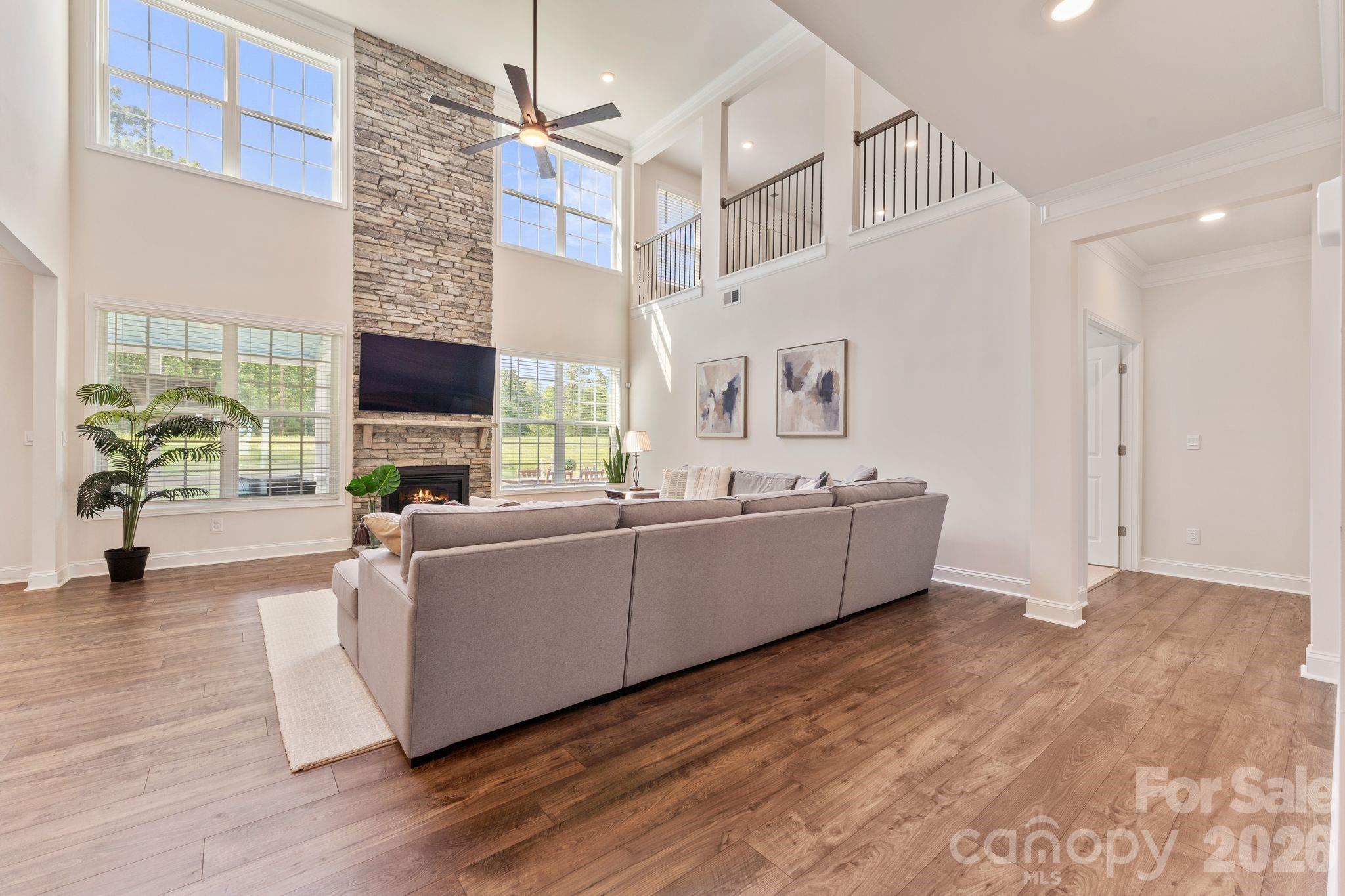 Experience the perfect blend of space, comfort, and outdoor living in this beautifully appointed Cypress Point home. This thoughtfully designed floor plan offers a spacious primary suite and formal dining room on the main level, with the flexibility to use the dining room as a home office, library, or sitting room.

The soaring two-story great room is filled with natural light and opens seamlessly to the kitchen, featuring granite countertops, a gas cooktop, double ovens, an oversized island, and a walk-in pantry. The primary suite includes an oversized walk-in shower, while a second washer and dryer hookup in the primary closet provides the option for main-level laundry in addition to the upstairs laundry room.

Upstairs, you'll find four additional bedrooms, three full bathrooms, a spacious loft, and an oversized storage closet, offering plenty of room to spread out.

Step outside to enjoy a screened porch overlooking a tree-lined backyard with seasonal views of Lake Wylie. The paver patio with a built-in fire pit creates an inviting outdoor living space, while the cul-de-sac lot, oversized driveway, and tankless water heater add everyday convenience and efficiency.

Residents of Cypress Point enjoy amenities including a clubhouse, pool, playground, picnic area, pickleball courts, and sidewalks, all just minutes from Lake Wylie, shopping, dining, and everyday conveniences.
