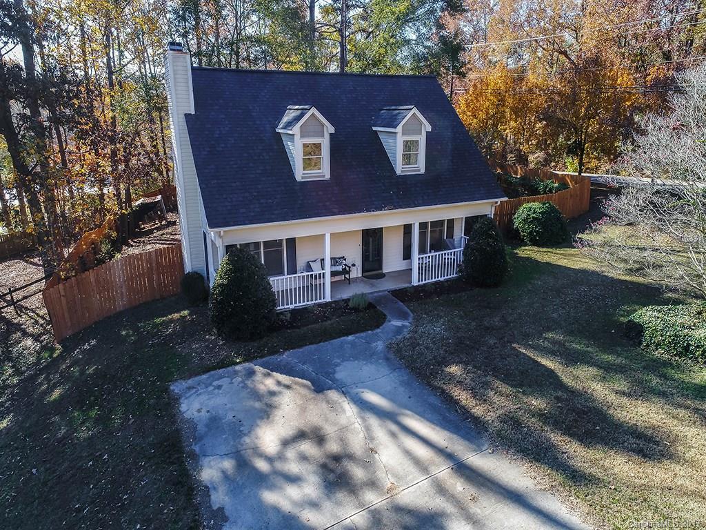 Beautiful, well kept home in quiet, wooded neighborhood just minutes from downtown Fort Mill, I-77, and popular Baxter Village. Custom cabinets, ss appliances, and granite countertops in kitchen. Laminate wood flooring on entire lower level with lots of storage throughout. Corner lot with new 6' privacy fence surrounds entire back yard with outdoor patio and storage building. Natural light fills every room and the stone, wood-burning fireplace invites you to sit and relax every evening.